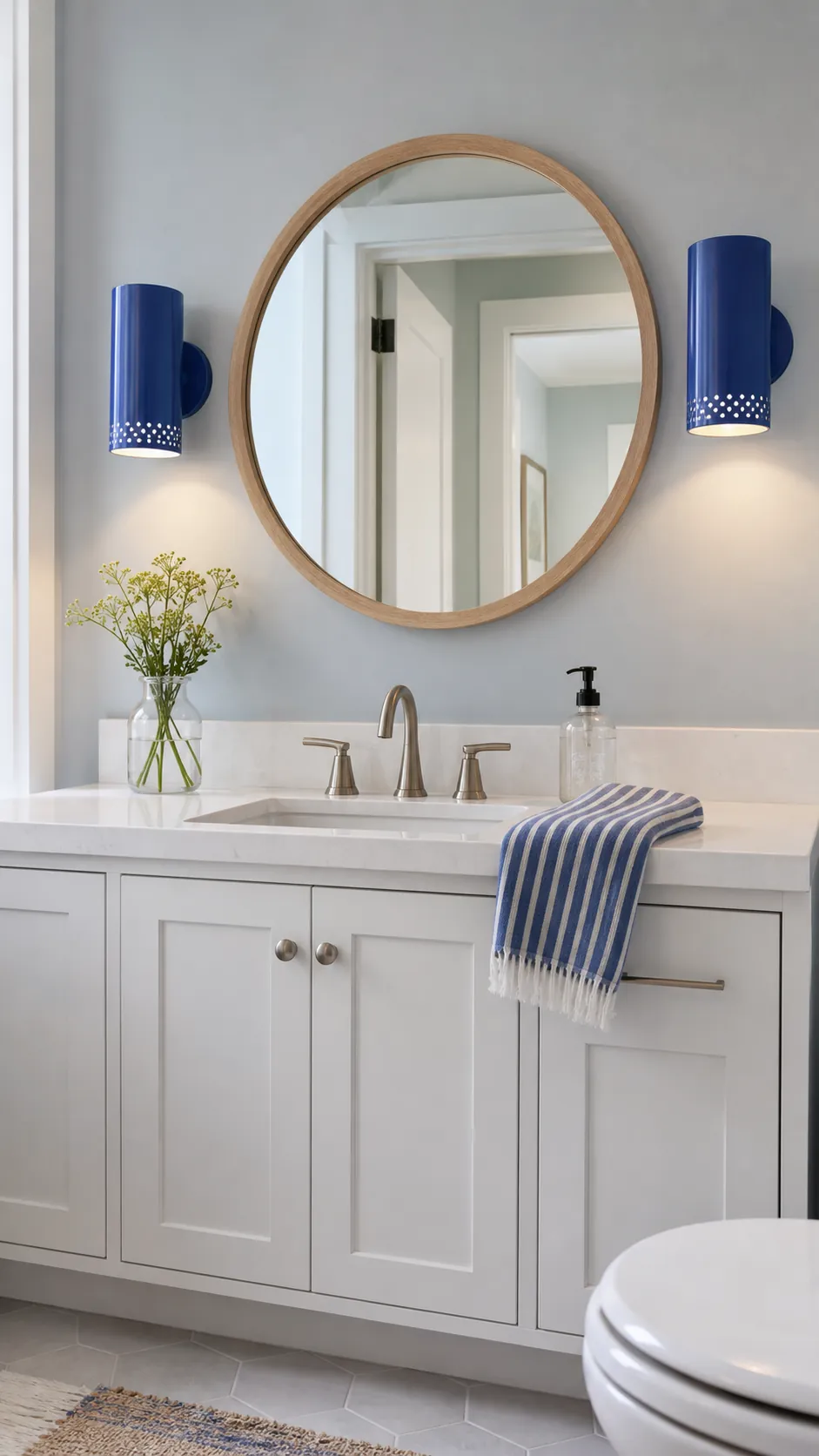 Blue Ceramic Sconces as the Color Moment beside a bathroom mirror