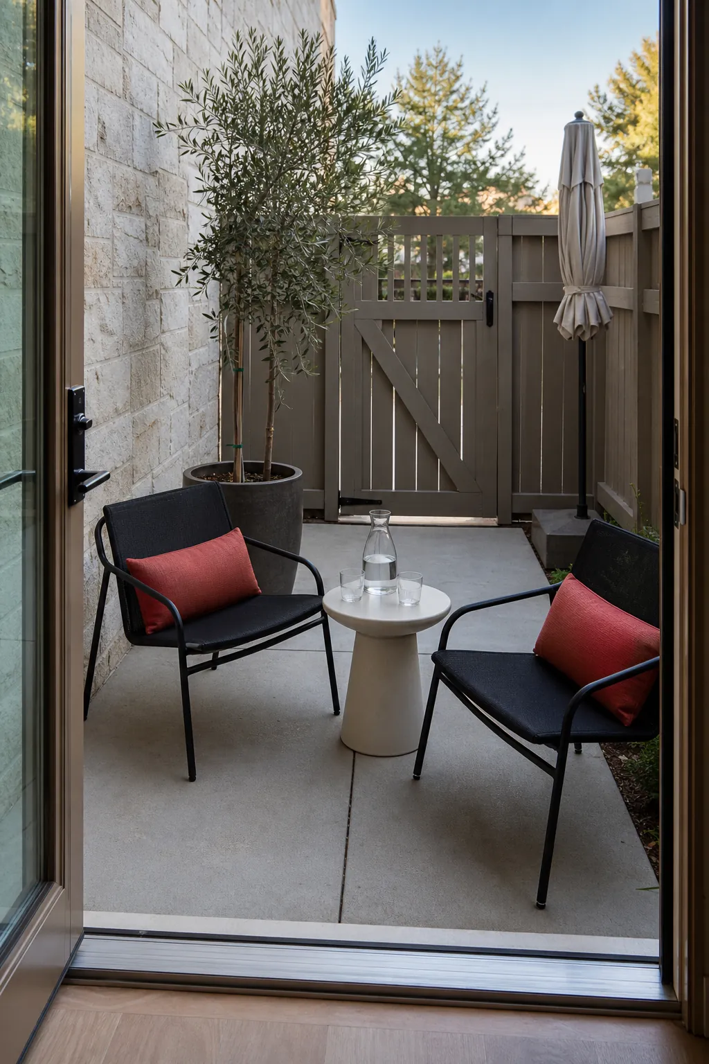 Small townhouse patio arranged as a two-person conversation nook