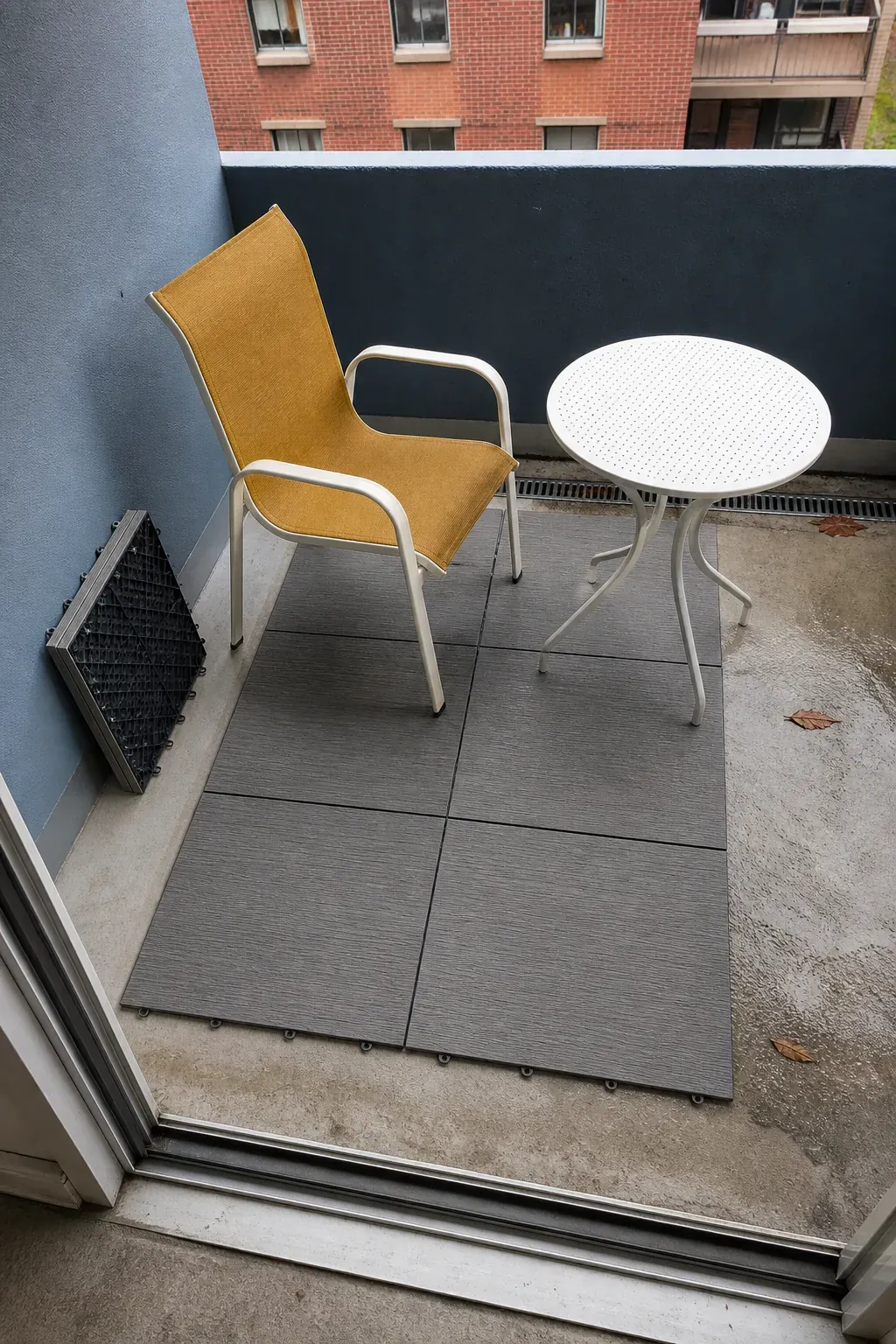 Apartment patio with a small dry zone of removable deck tiles
