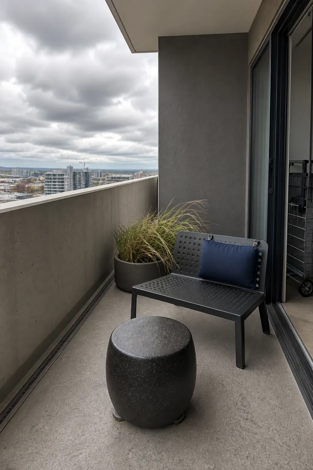 Upper-floor apartment balcony with low wind-conscious furniture