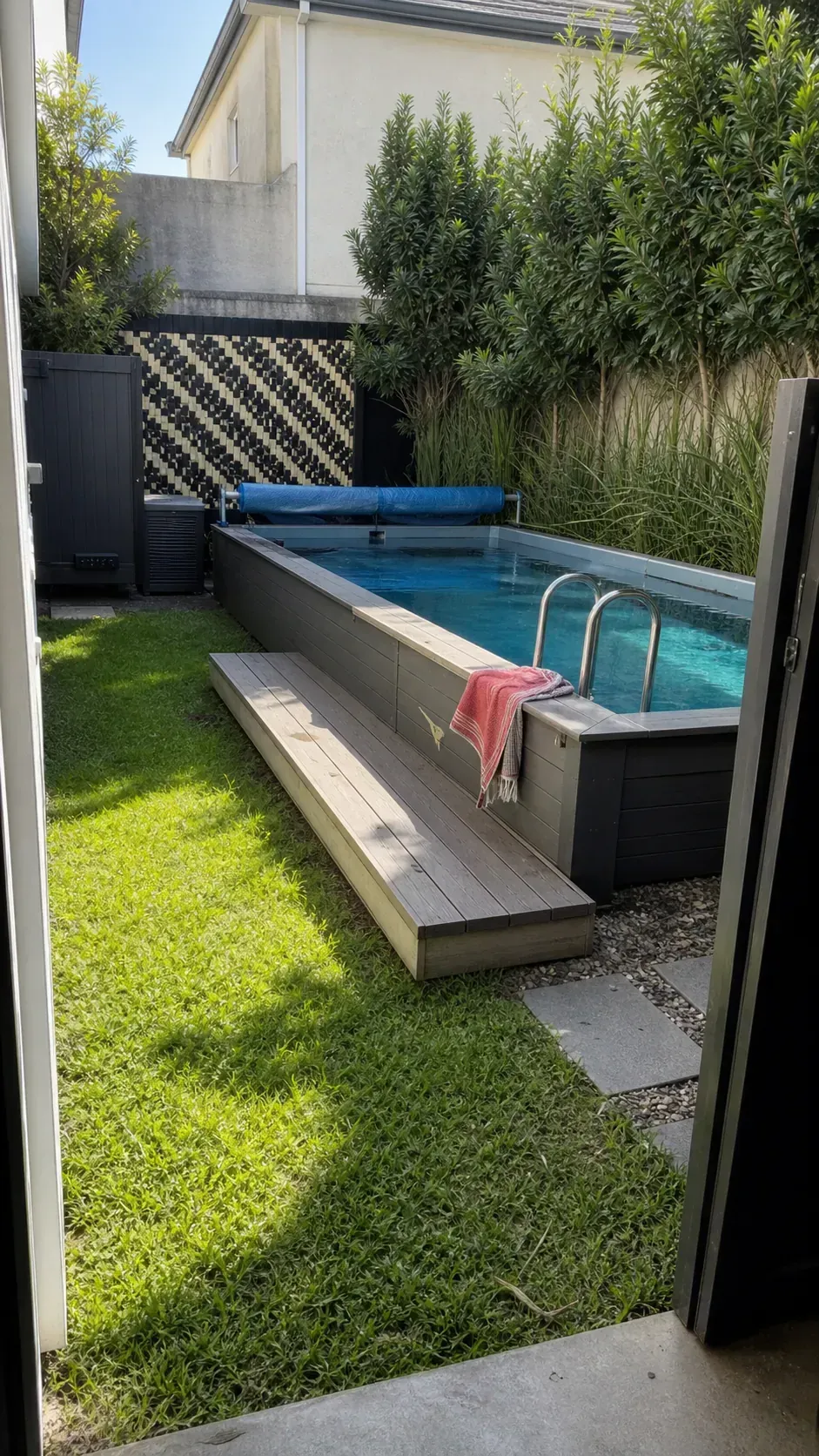 Rectangular above-ground pool tucked into a landscaped backyard corner