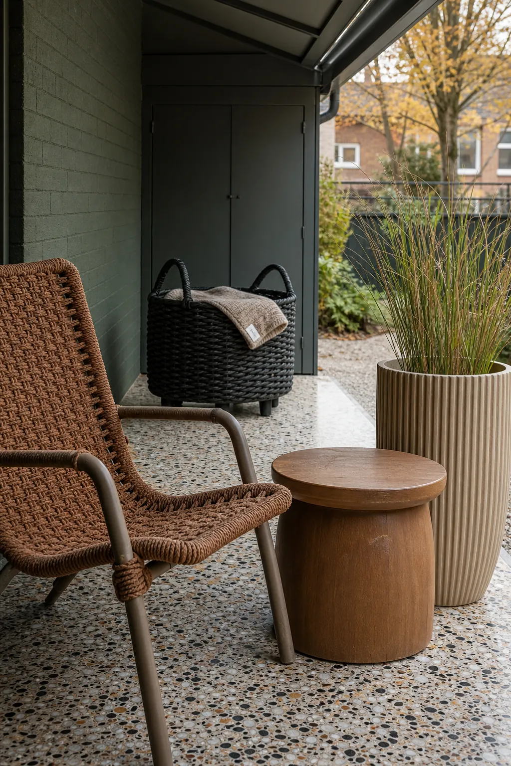 Small patio layered with woven chair rope basket and planter textures