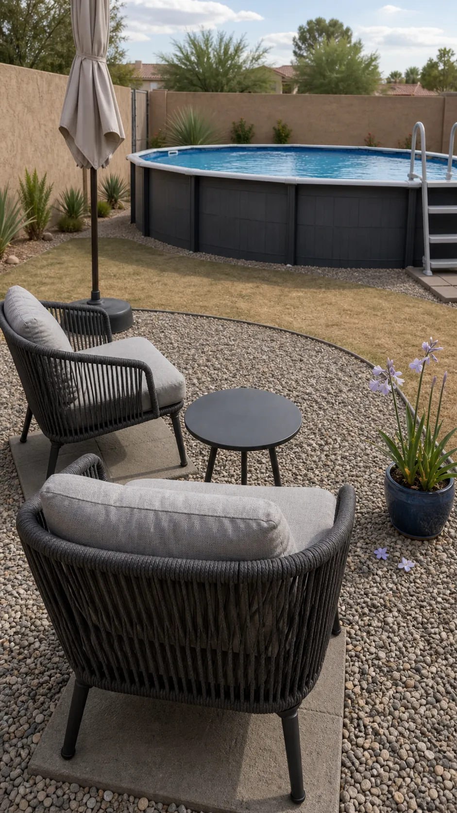 Small pea-gravel lounge area with two chairs beside an above-ground pool