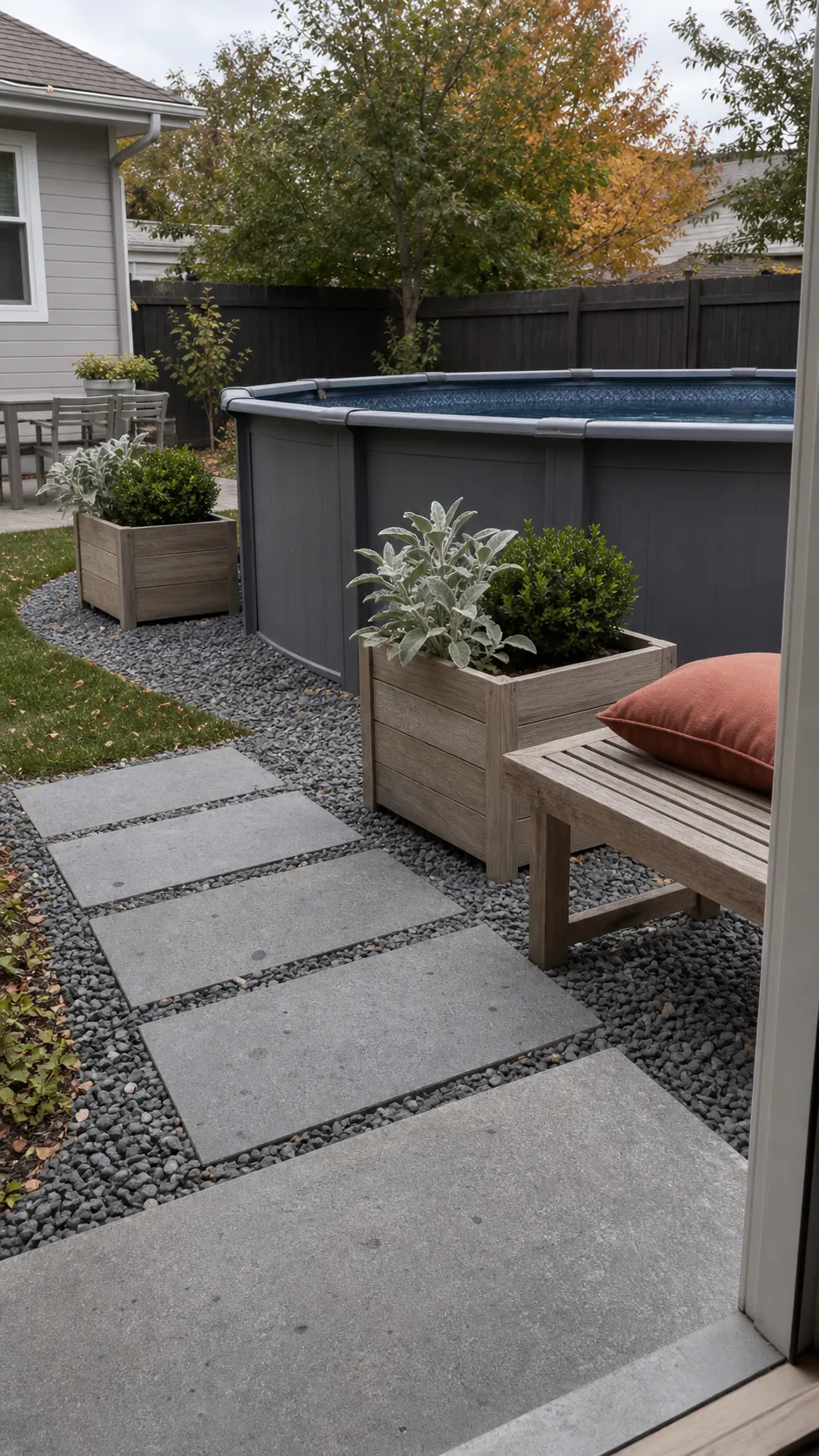 Coordinated gray gravel timber and planters around an above-ground pool