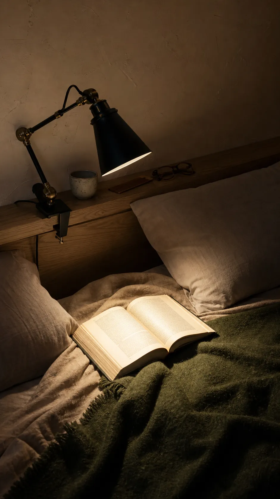 Adjustable reading lamp directing a narrow beam onto a book
