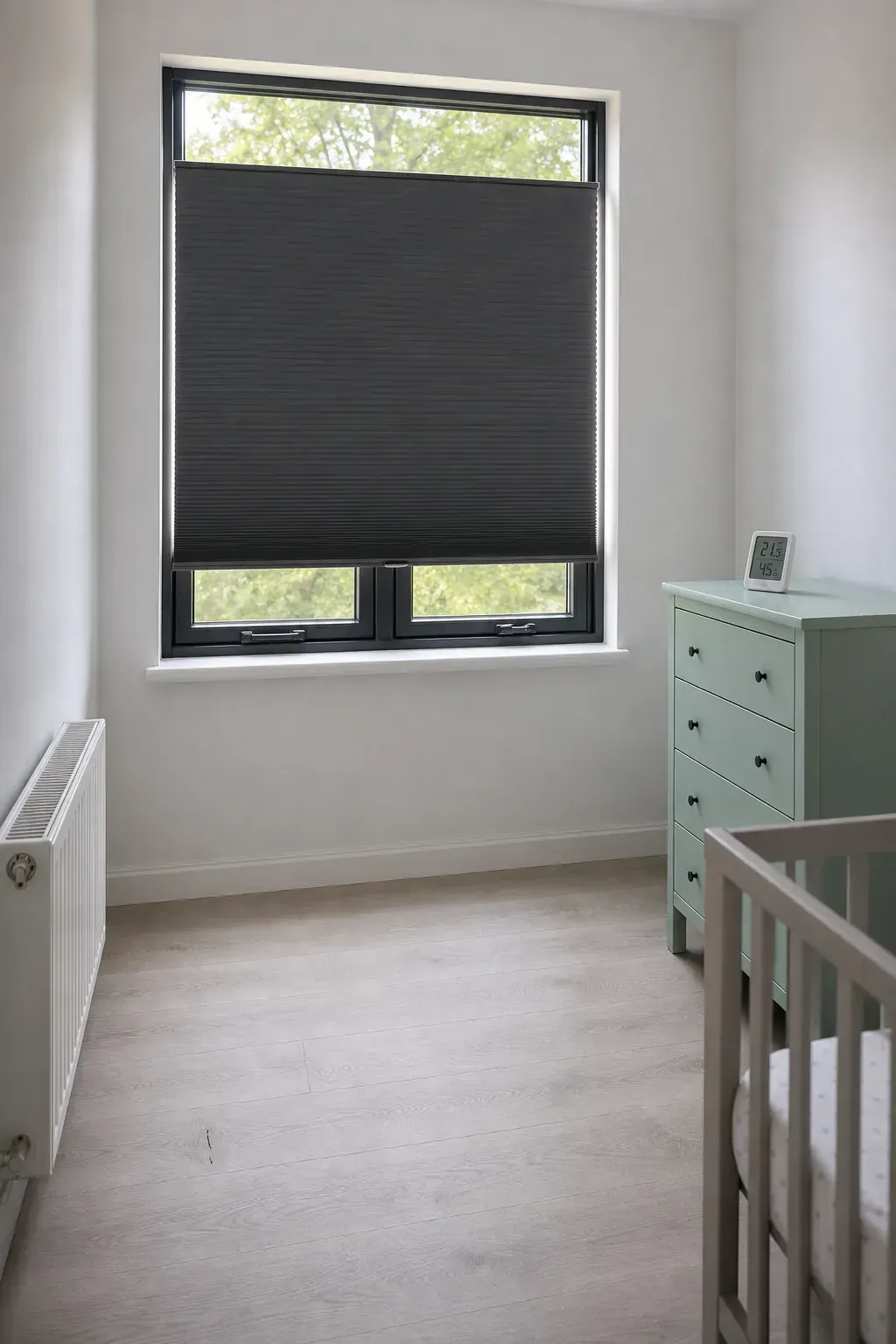 Cordless blackout shade installed in a small nursery