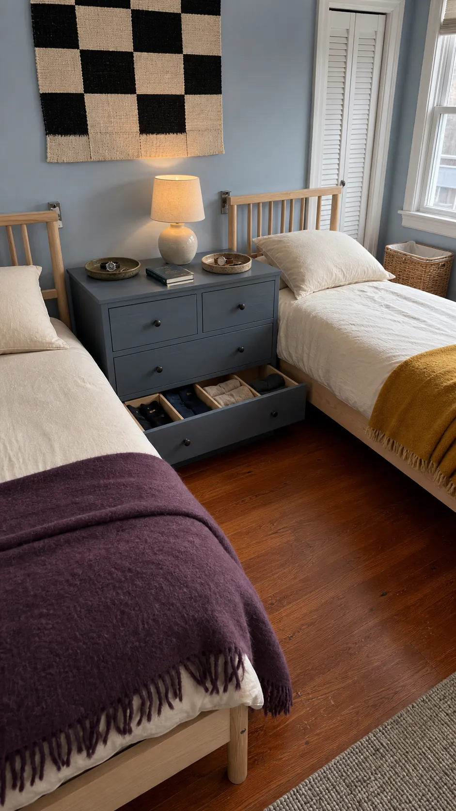 Shared low dresser positioned between two twin beds