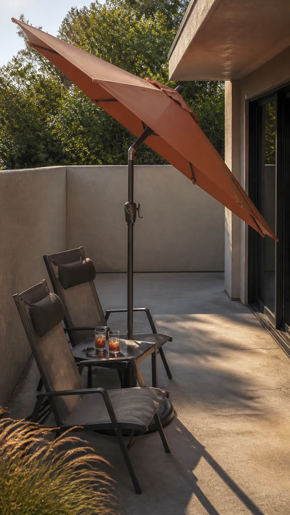 Tilting umbrella blocking low afternoon sun on a small patio