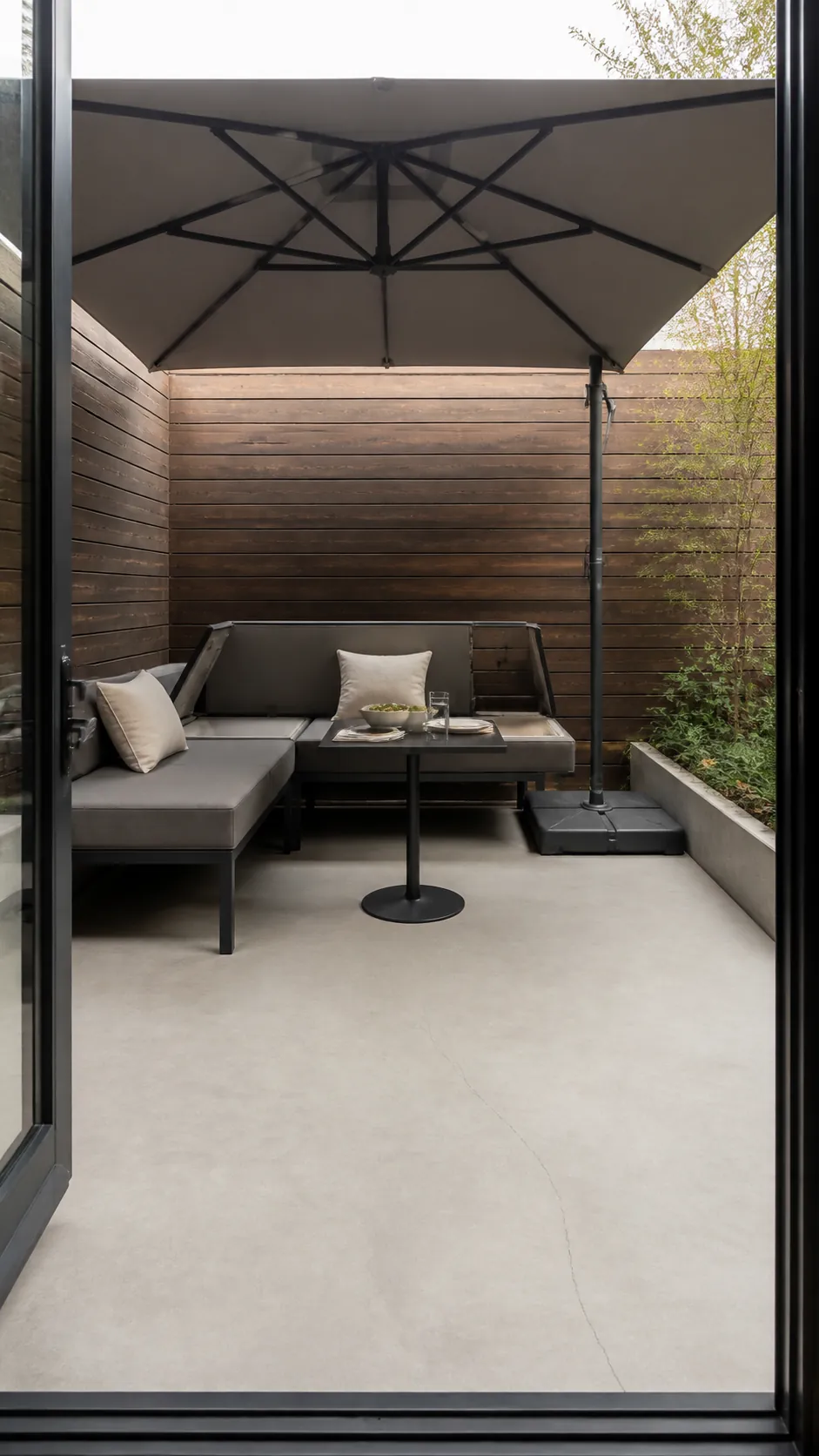 Square umbrella shading a compact corner banquette