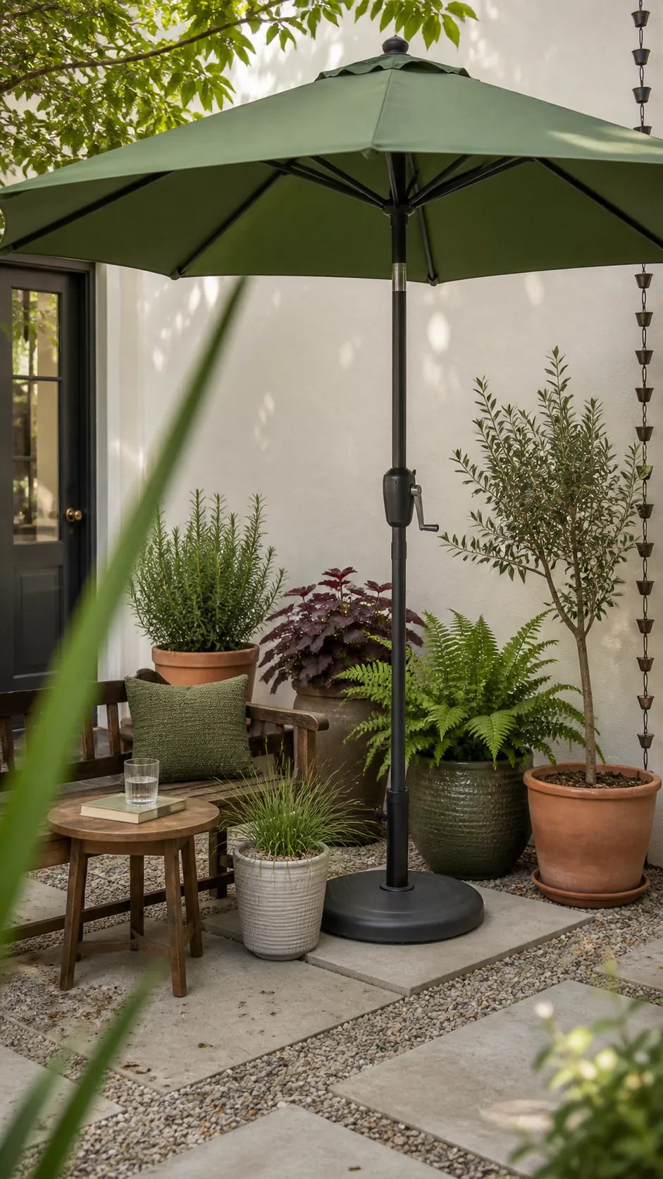 Leaf-green umbrella blending with container plants on a tiny patio