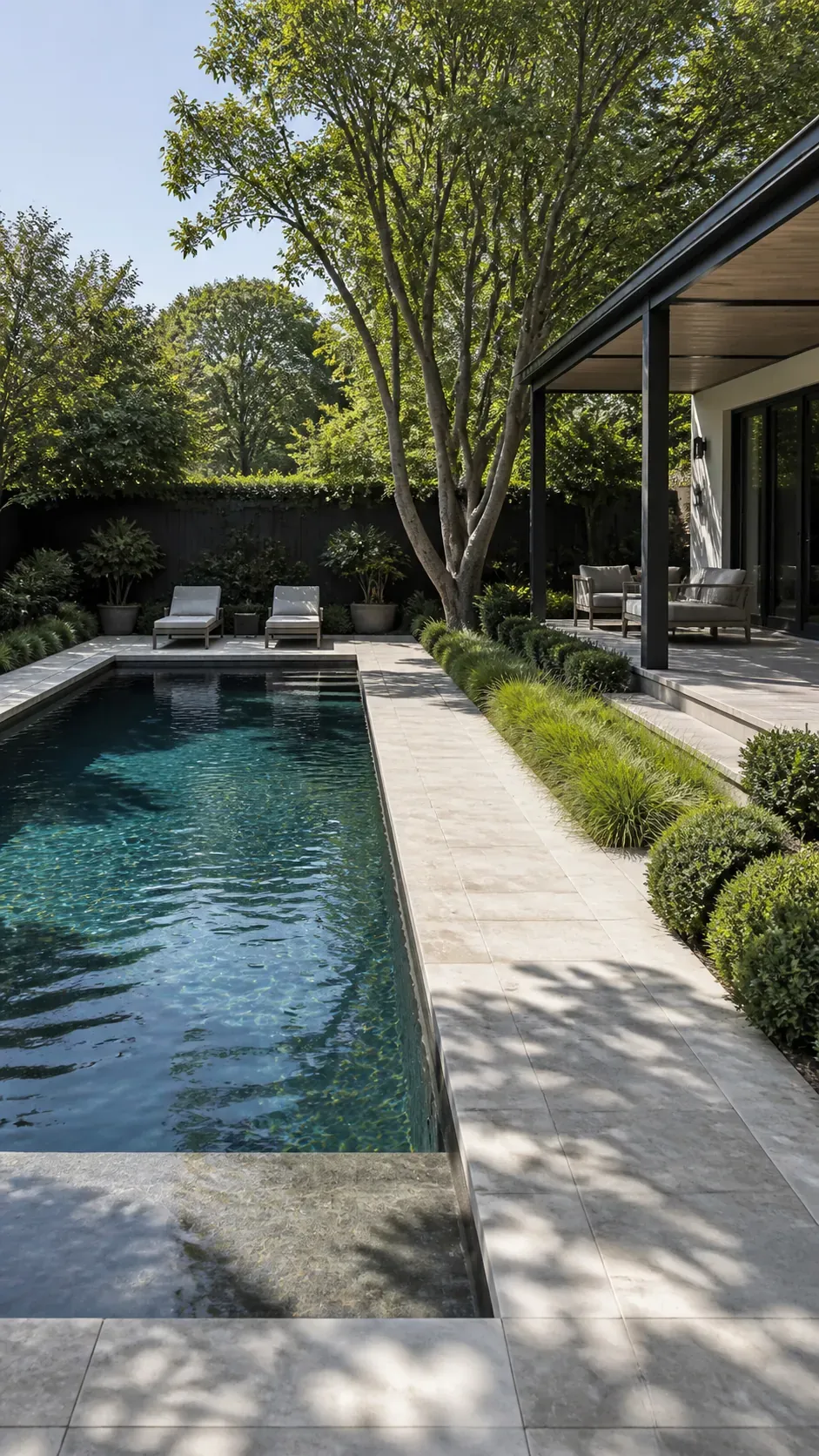 Modern backyard pool with clean geometric lines and restrained landscaping