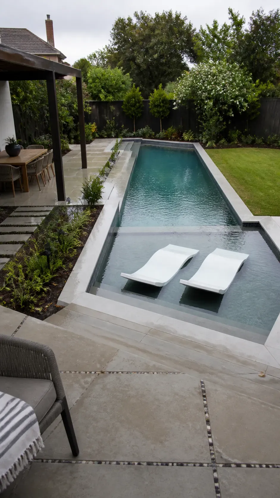Modern L-shaped pool defining separate swimming and lounge zones