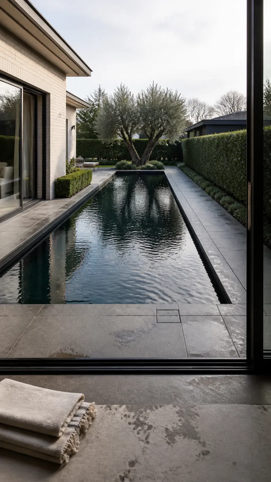 Long modern rectangular pool aligned with the main backyard view