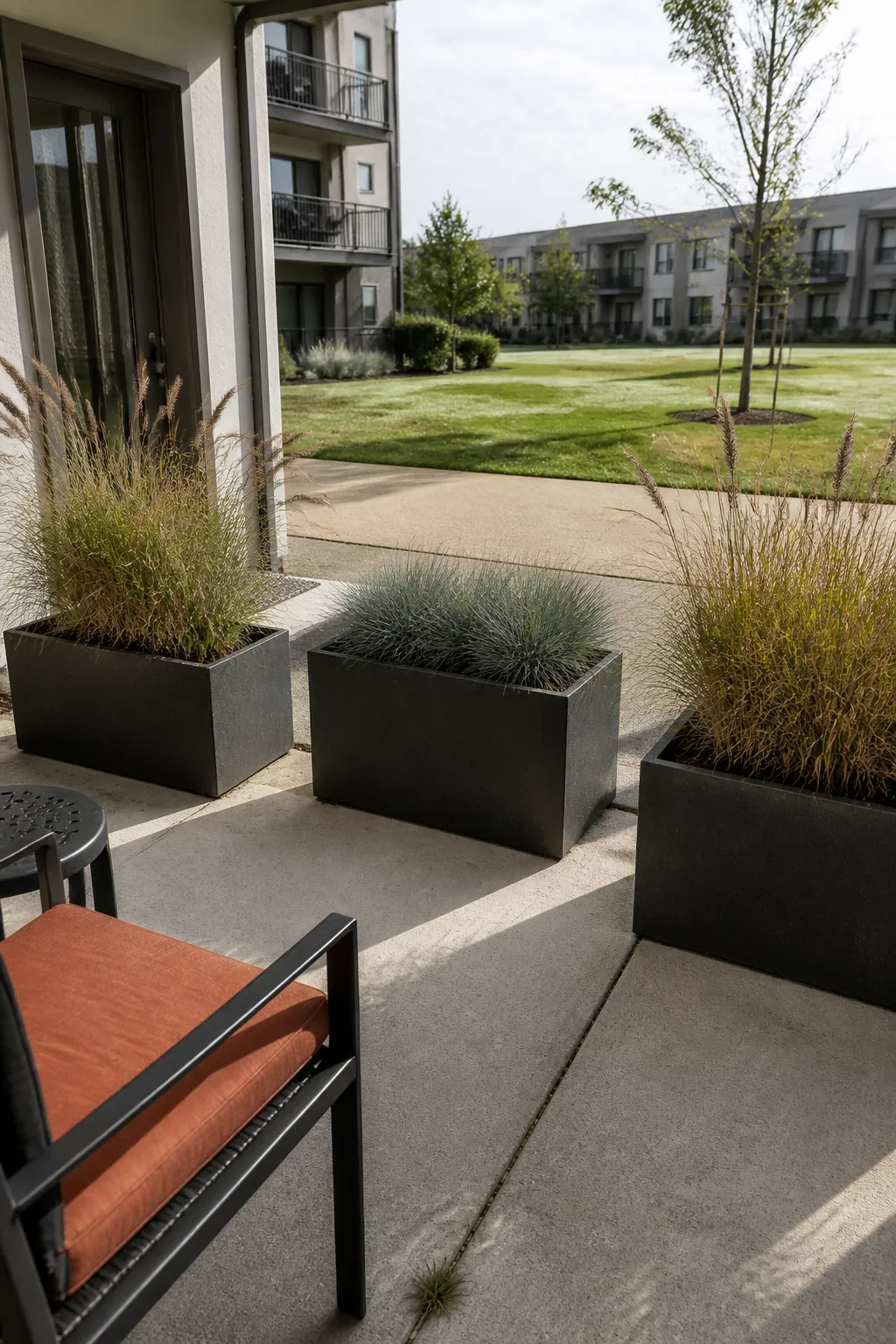 Stable containers of ornamental grass filtering a shared patio path