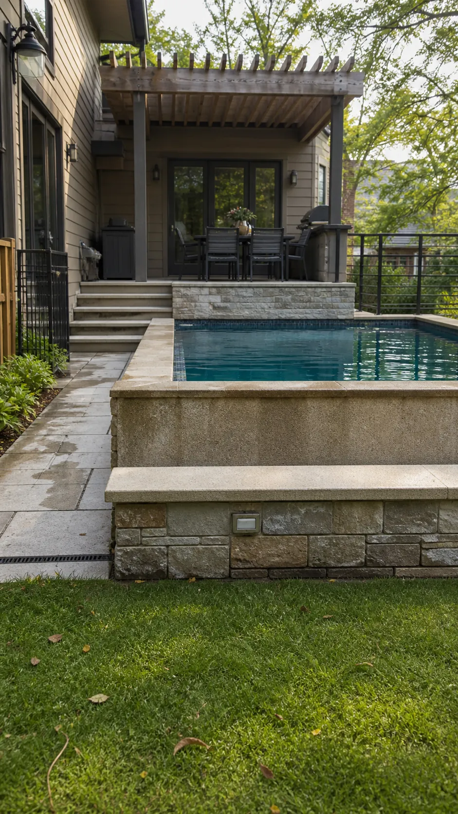 Raised pool connecting an upper terrace with a lower lawn