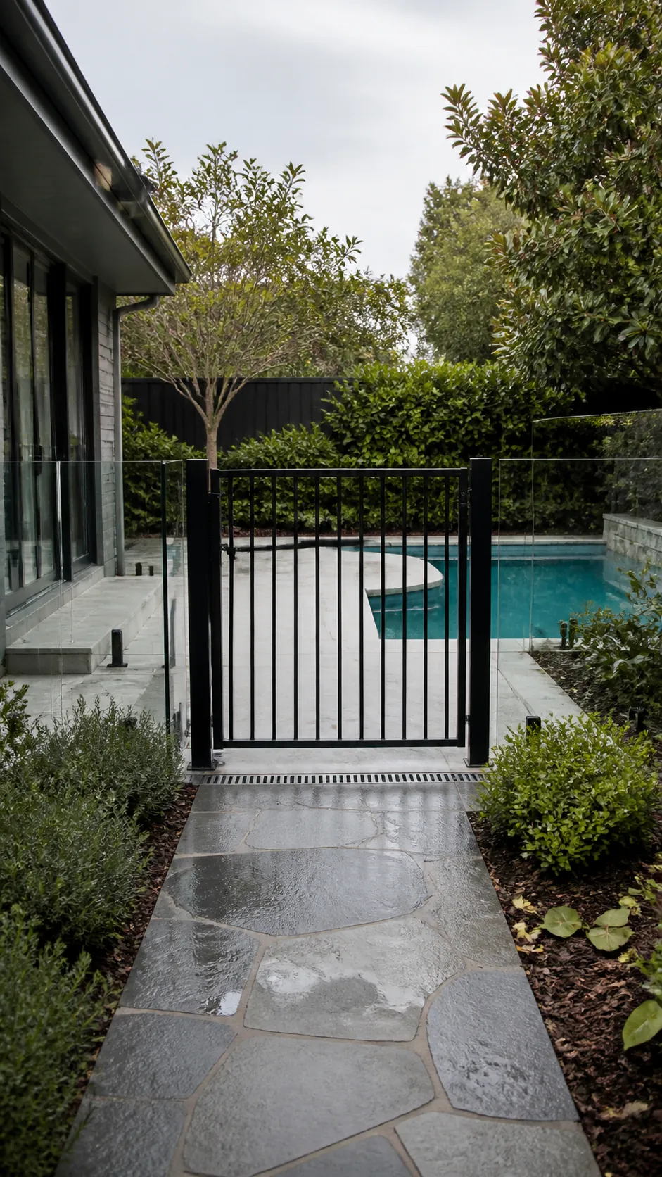Backyard pool layout with a safety gate integrated into the arrival path