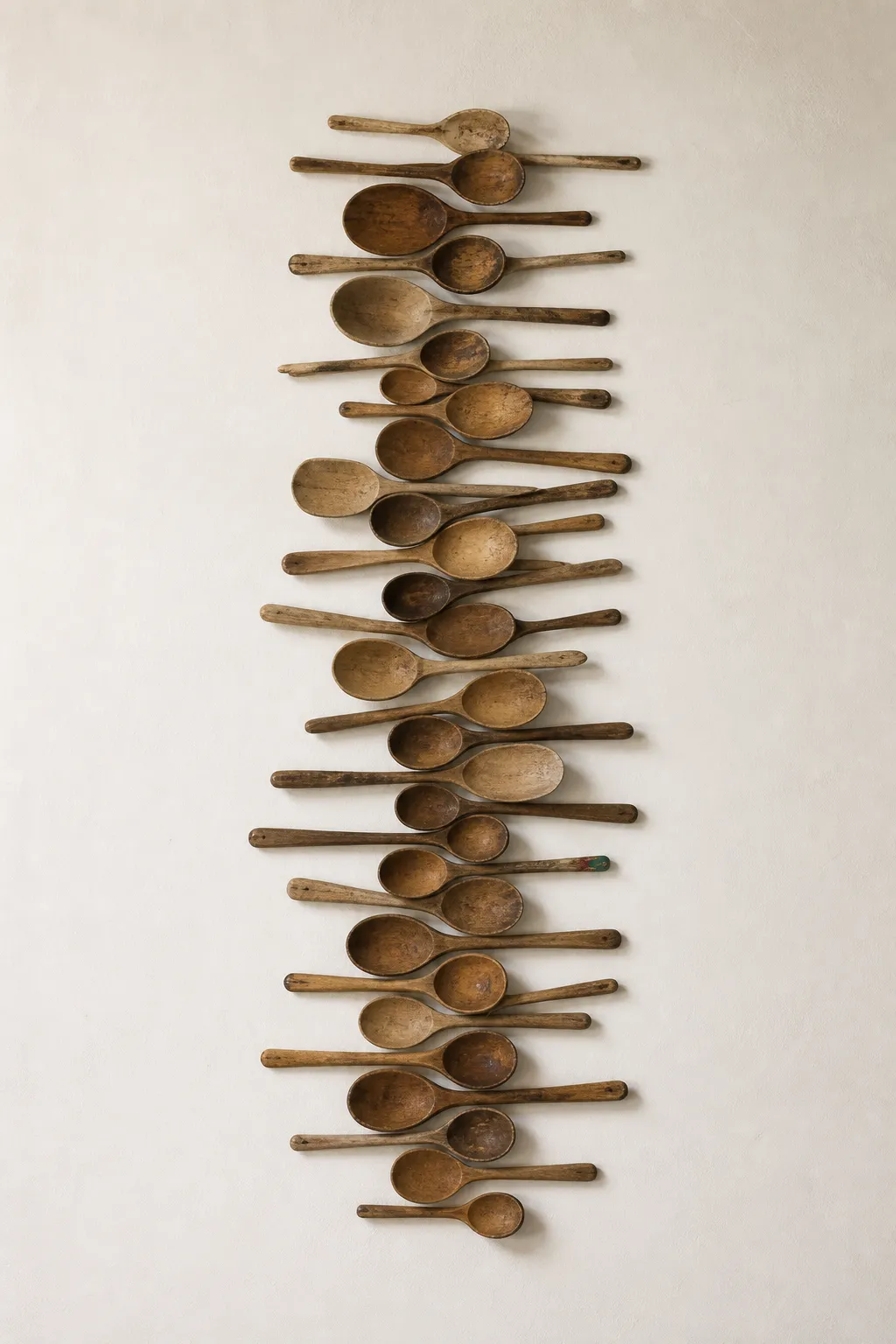 Vintage wooden spoons mounted in simple frames as kitchen wall art