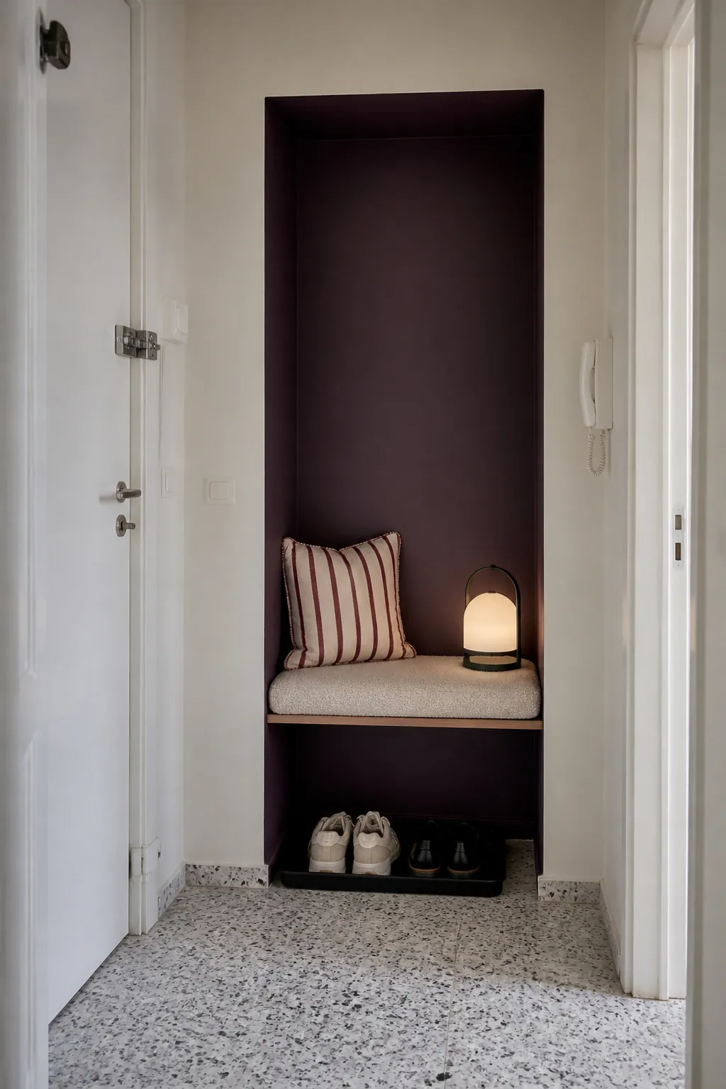 Color-wrapped architectural niche adding personality to a small rental apartment