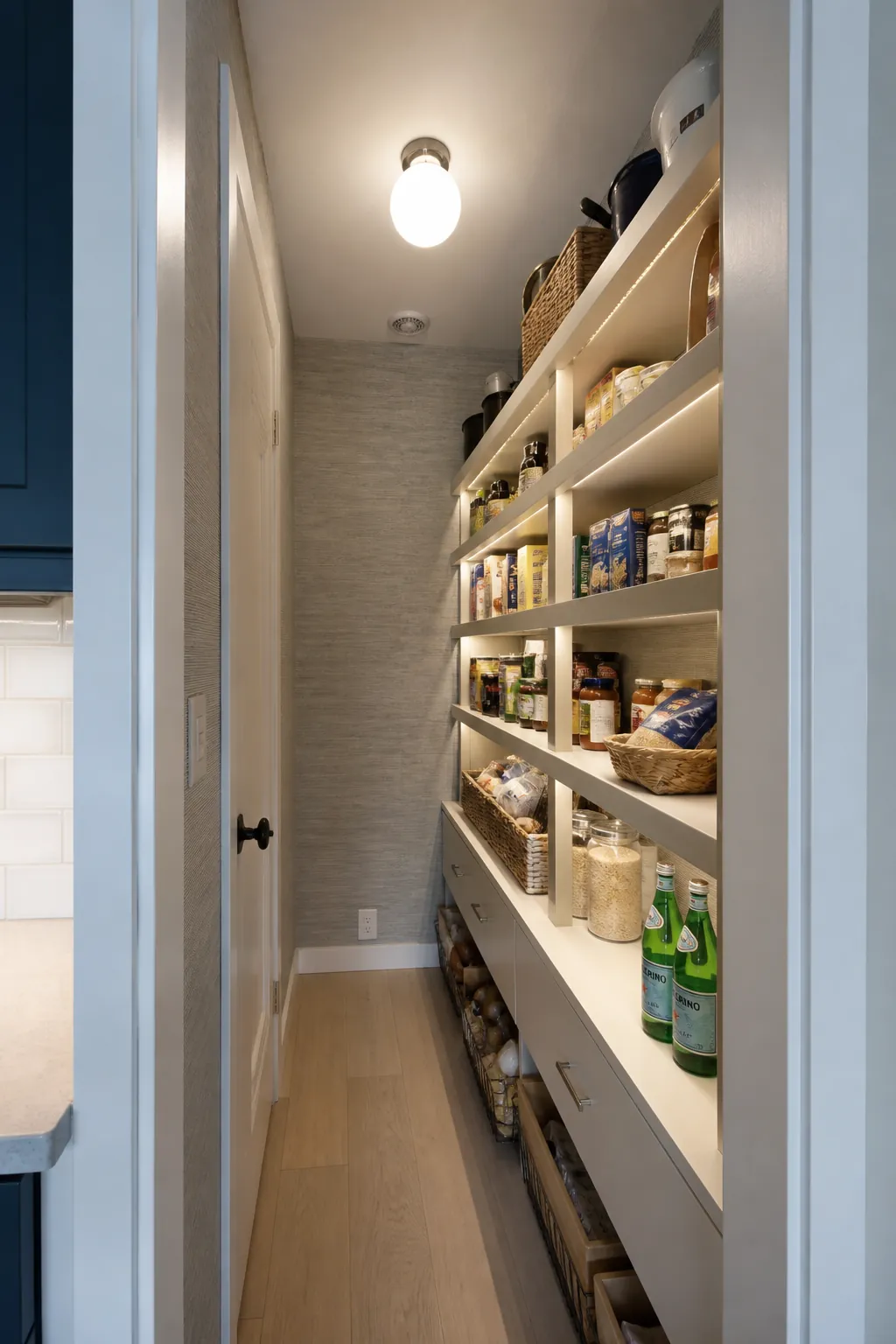 Narrow walk in pantry showing light the shelf faces