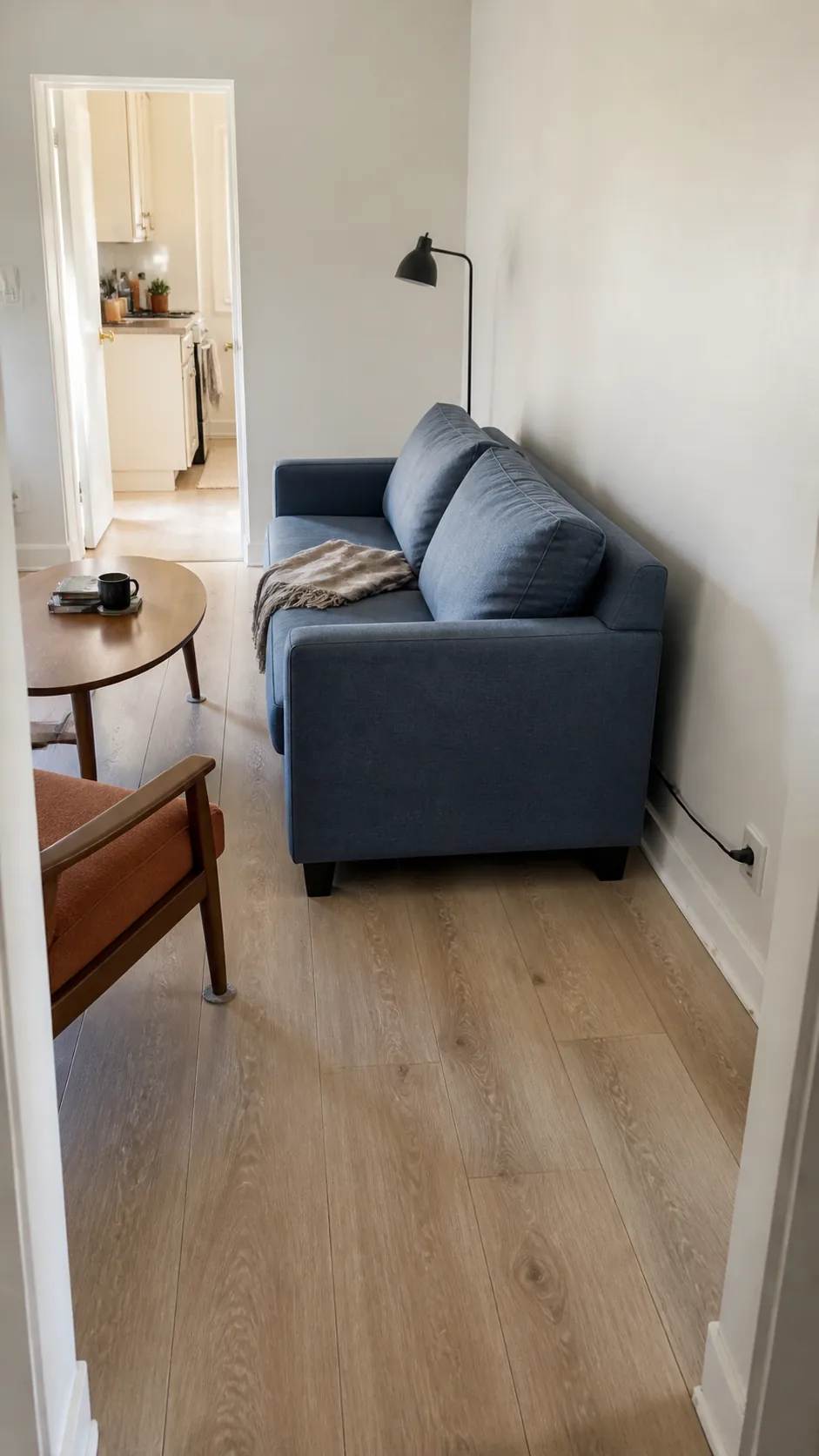 Small rental living room with sofa floated slightly from the wall