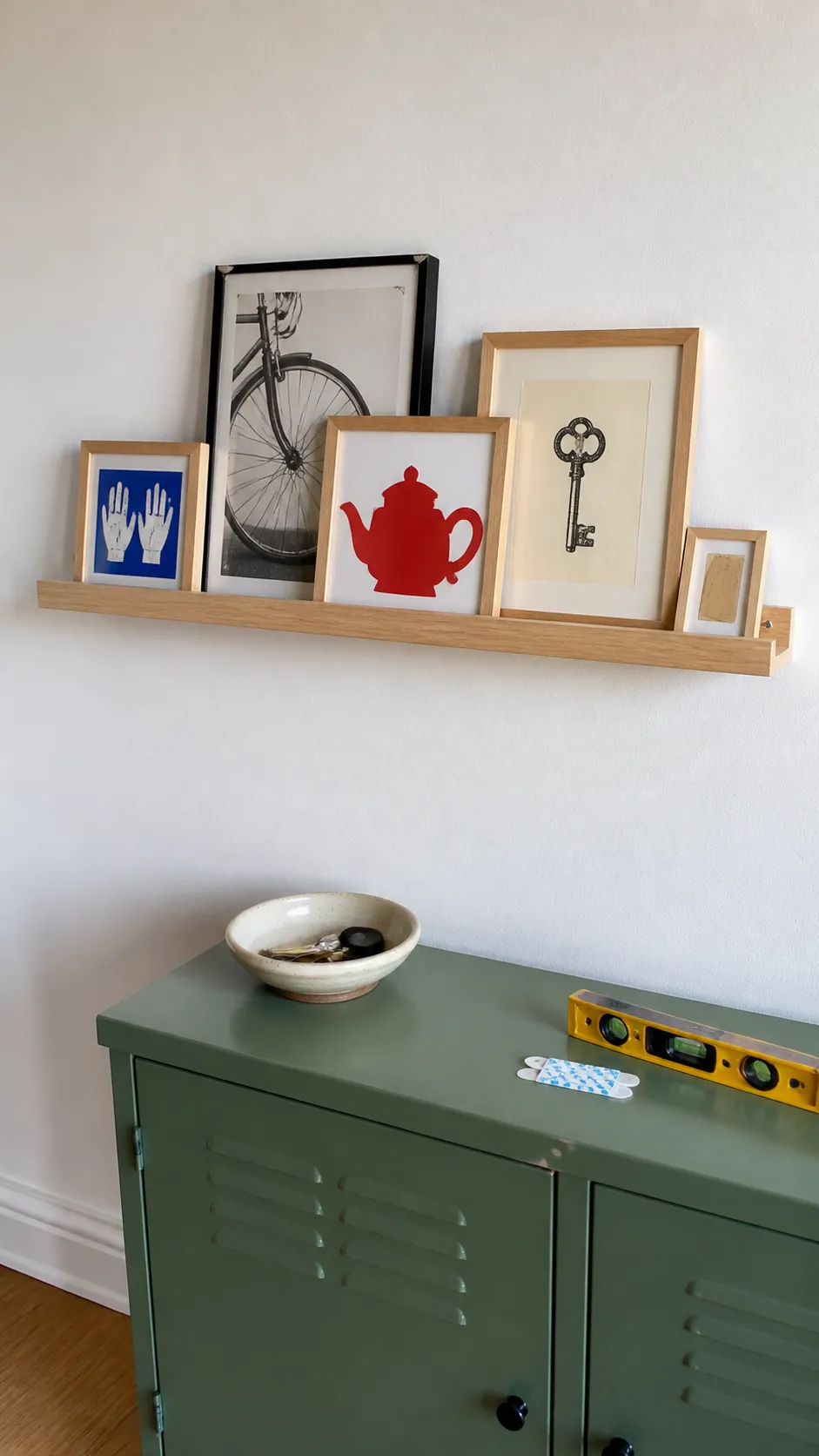 Renter friendly picture ledge with lightweight personal prints