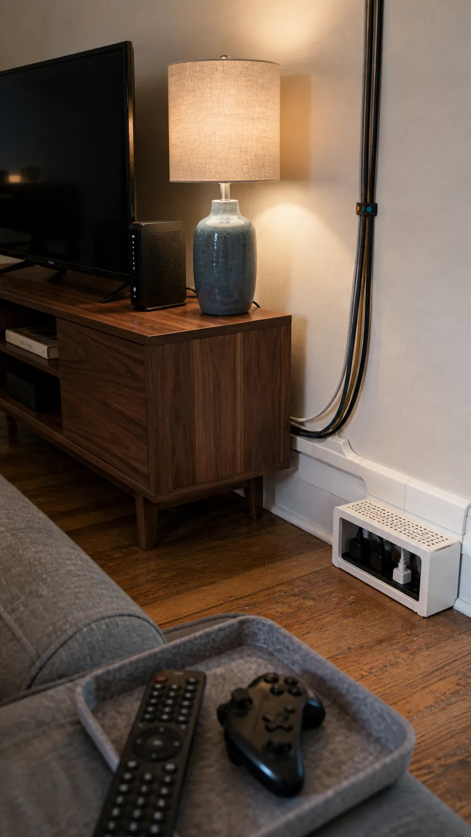 Neat removable cord raceway beside a rental living room console