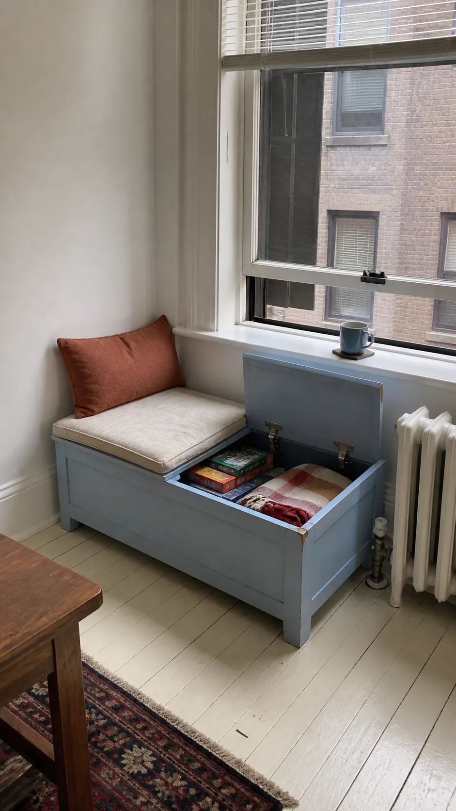 Low storage bench creating a small rental apartment window seat