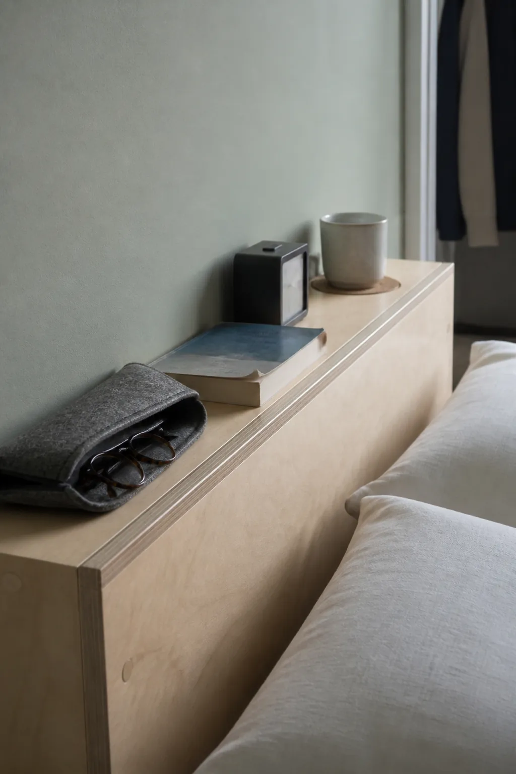 Shallow headboard shelf holding safe bedtime essentials