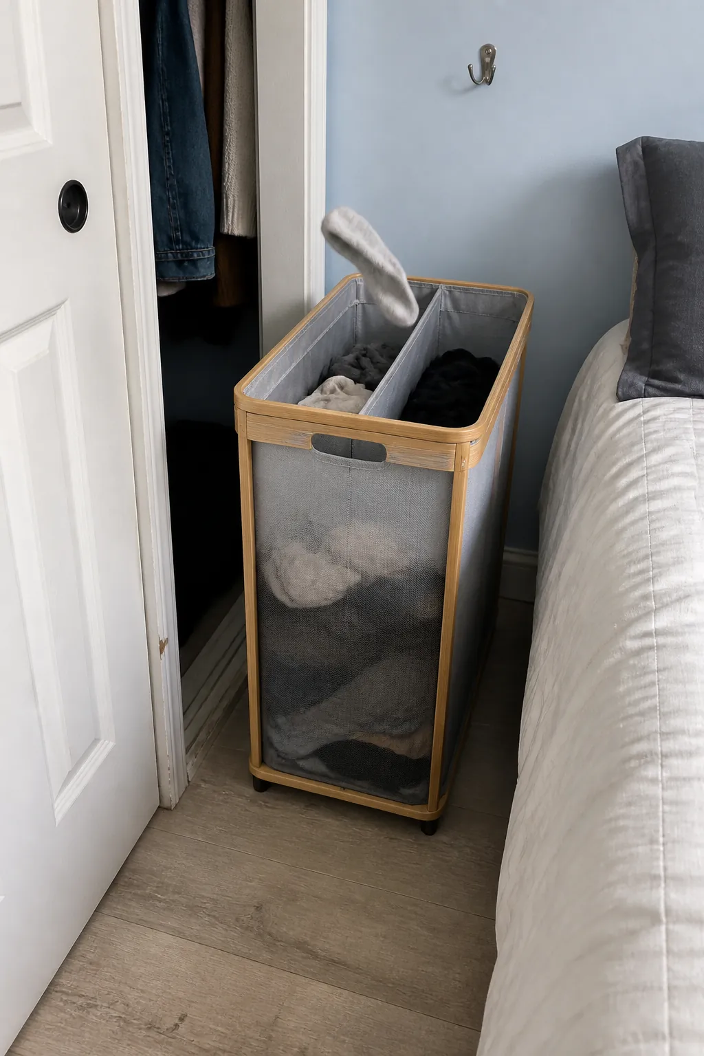 Tall narrow hamper fitting a very small apartment bedroom