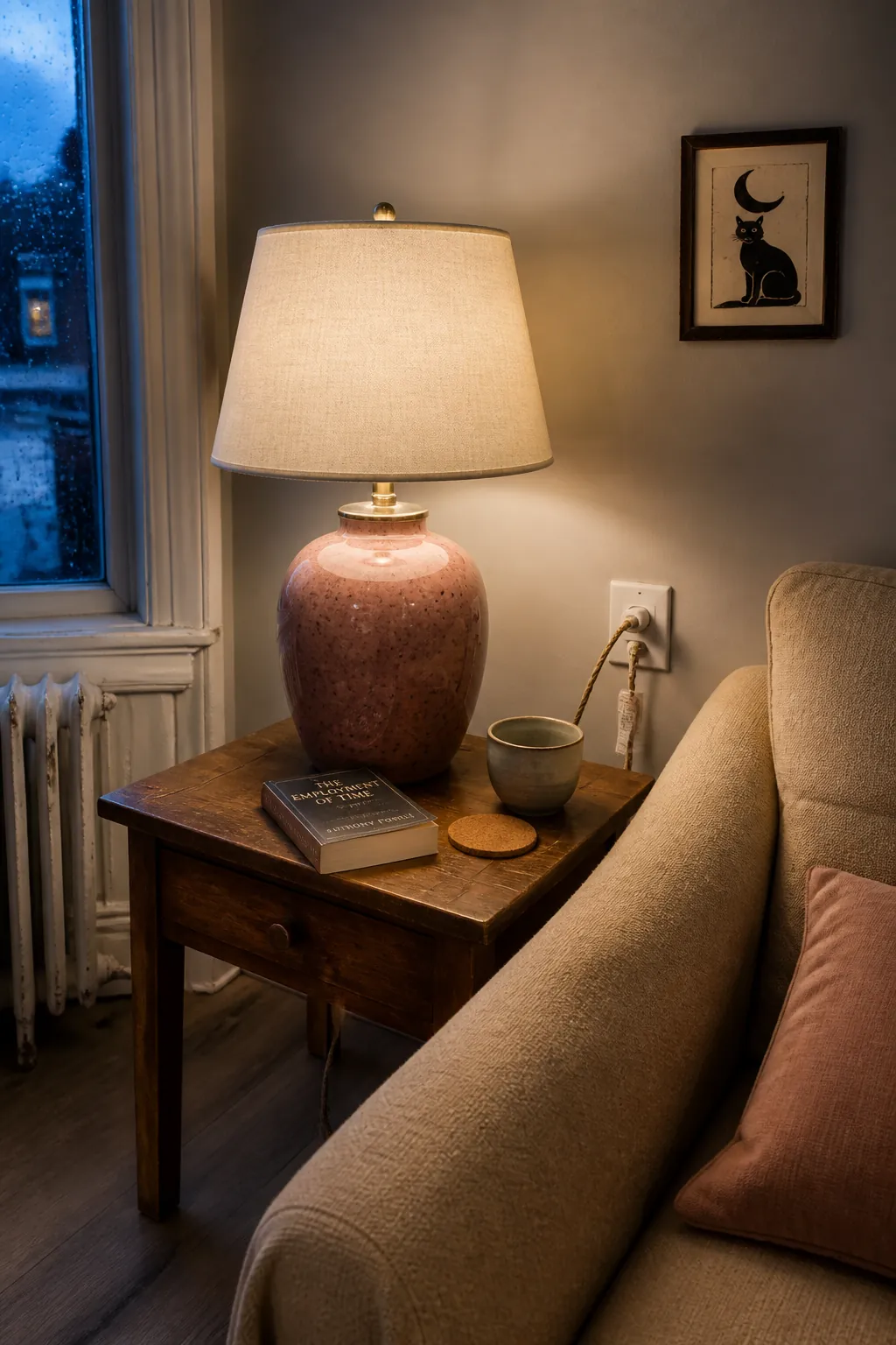Thrifted pink ceramic lamp adding personality to a tiny apartment