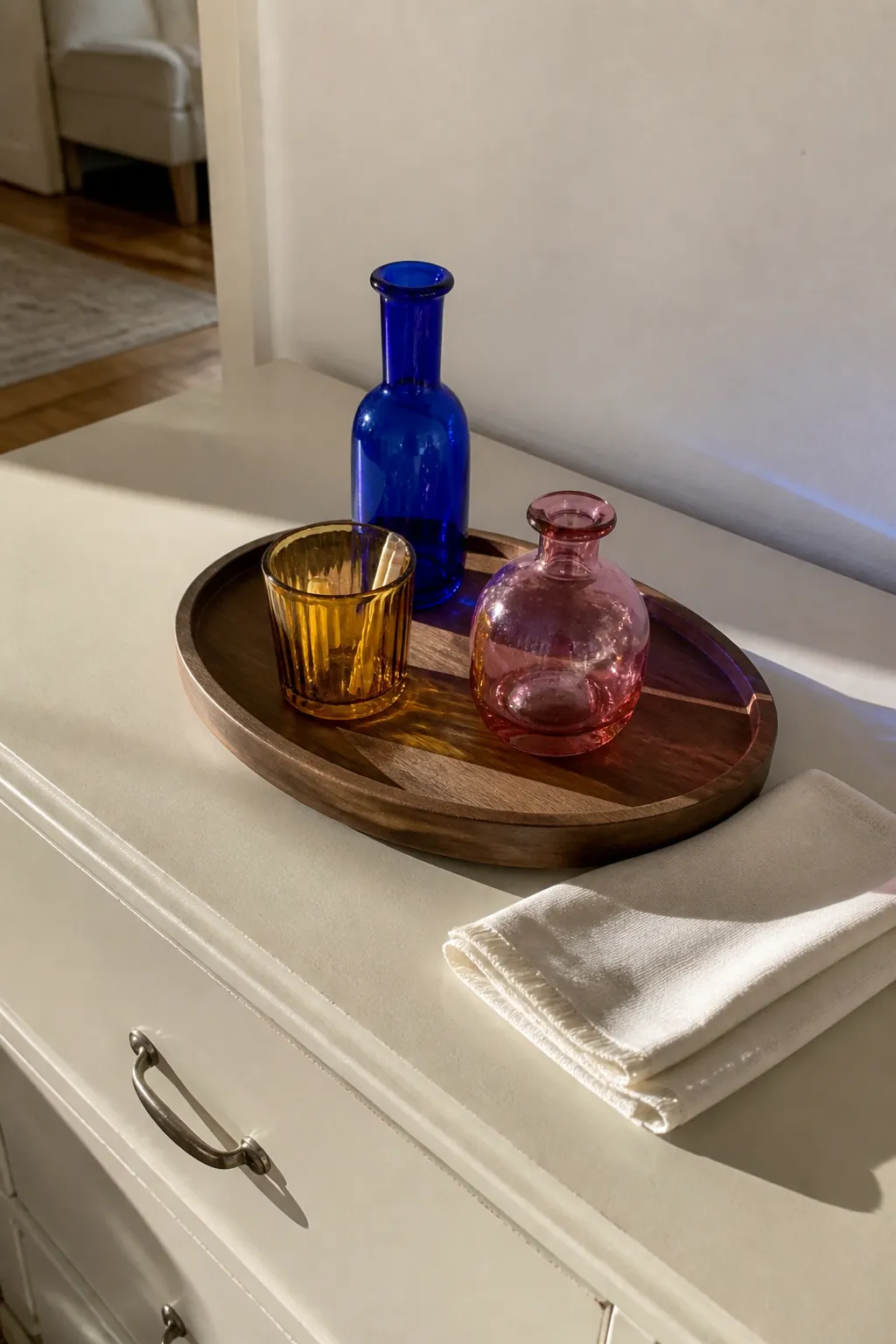Three colorful glass pieces grouped on one apartment tray
