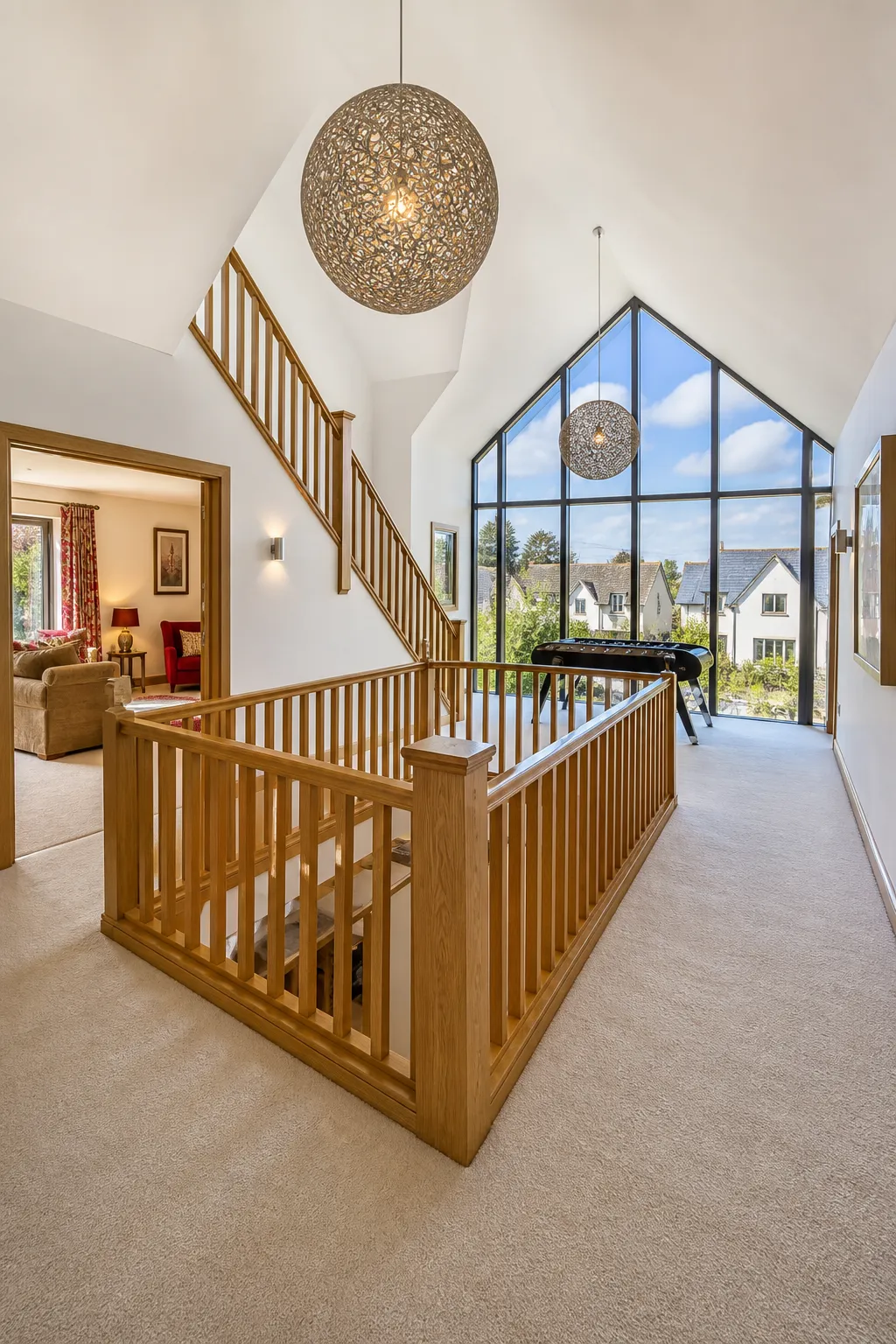 Bright wood-stair landing decorated with a curated upstairs art gallery