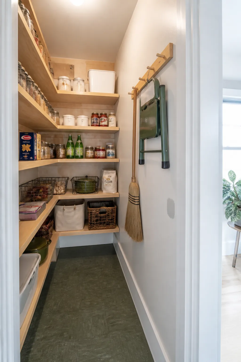 Narrow L-shaped walk-in pantry with one wall left open