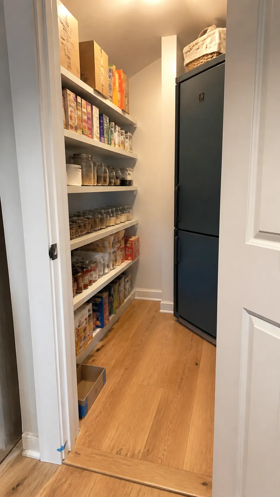Small walk-in pantry planned with full-scale shelf mockup