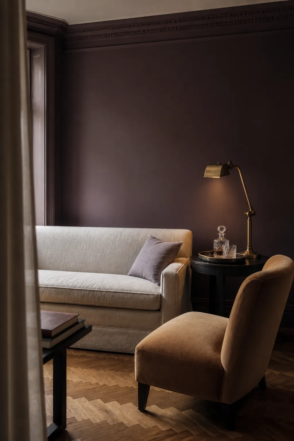 Plum brown living room with tailored cream sofa and aged brass lighting