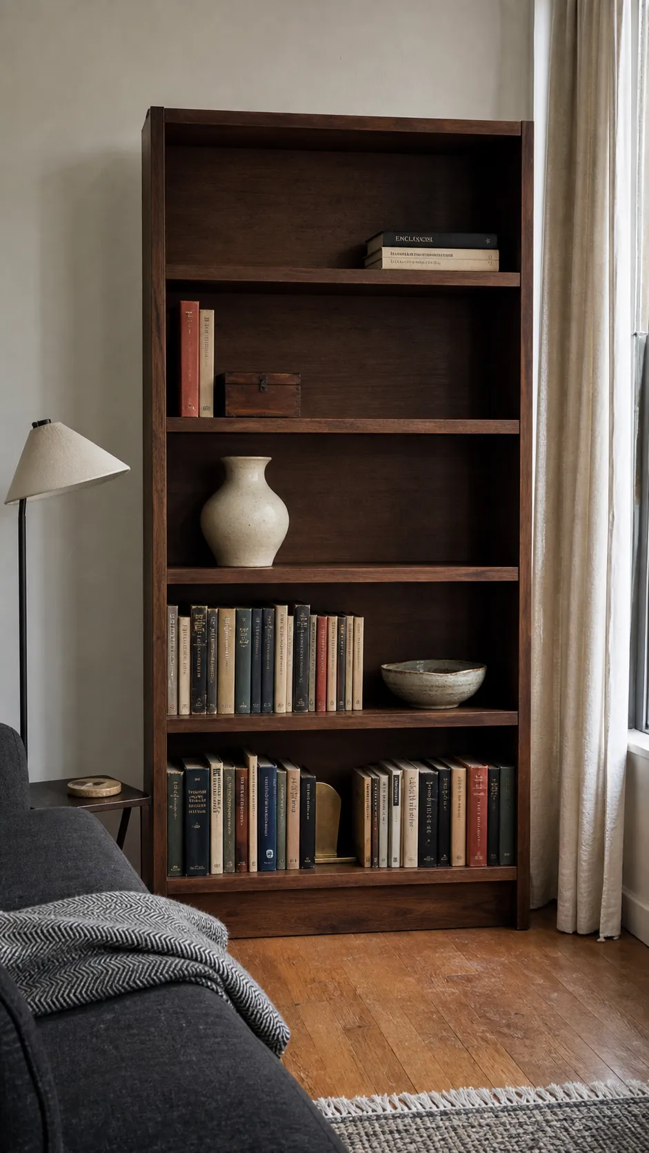 Bookcase styling with varied visual weight and intentional open space