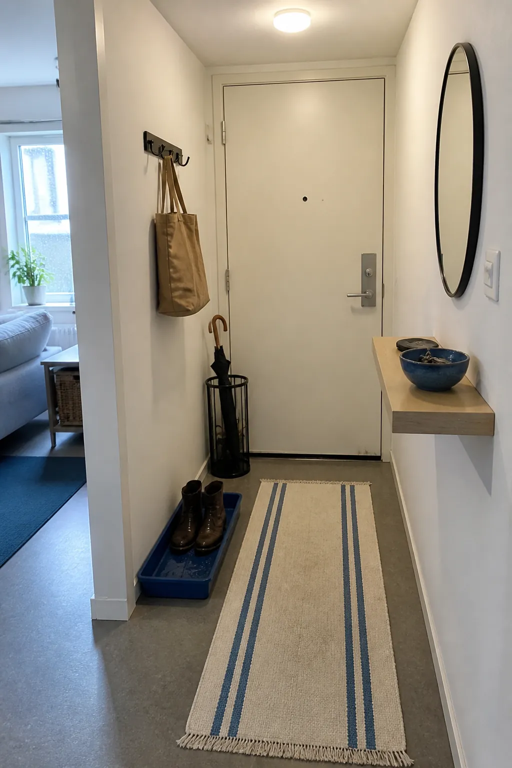 Cobalt accents defining a compact entry in a white rental apartment