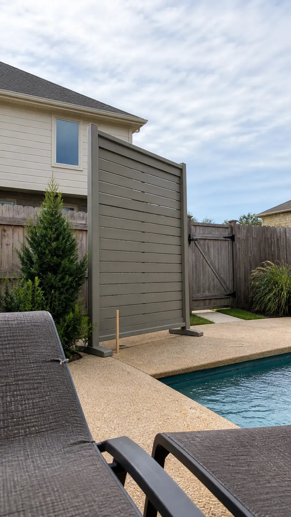 Targeted pool privacy screen positioned to block a neighboring upper window sightline