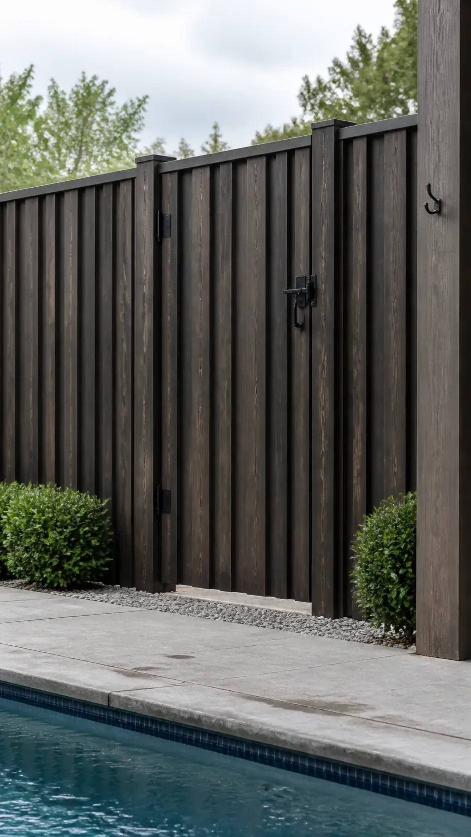 Textured vertical board fence enclosing a private residential pool