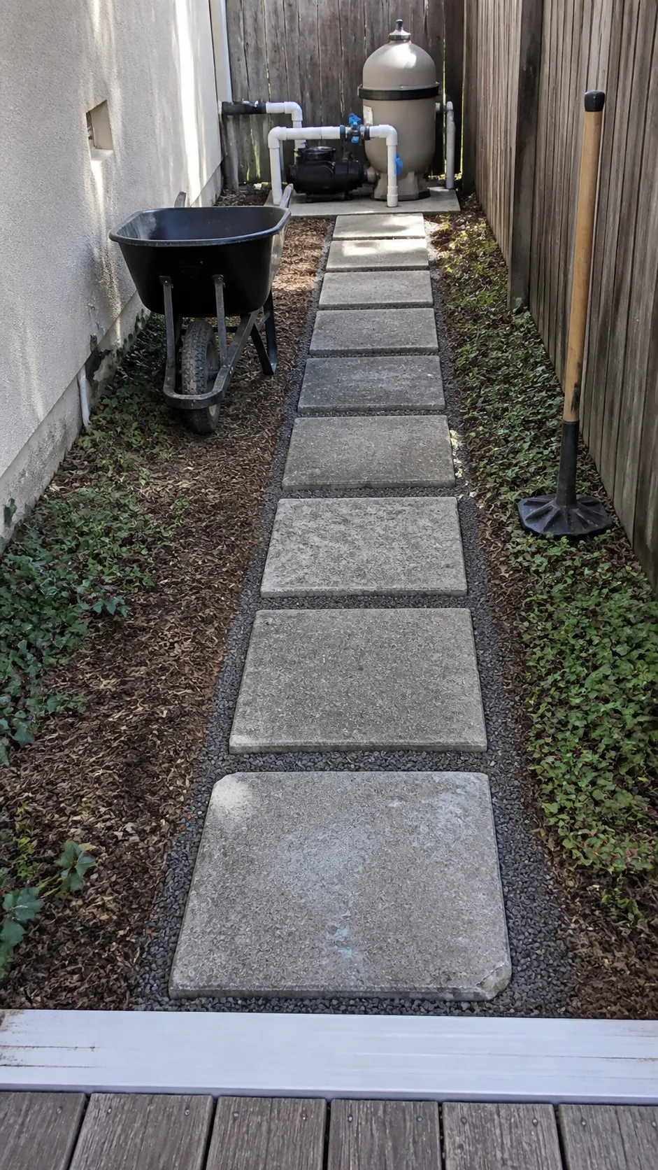 Reclaimed pavers forming an affordable service path to pool equipment