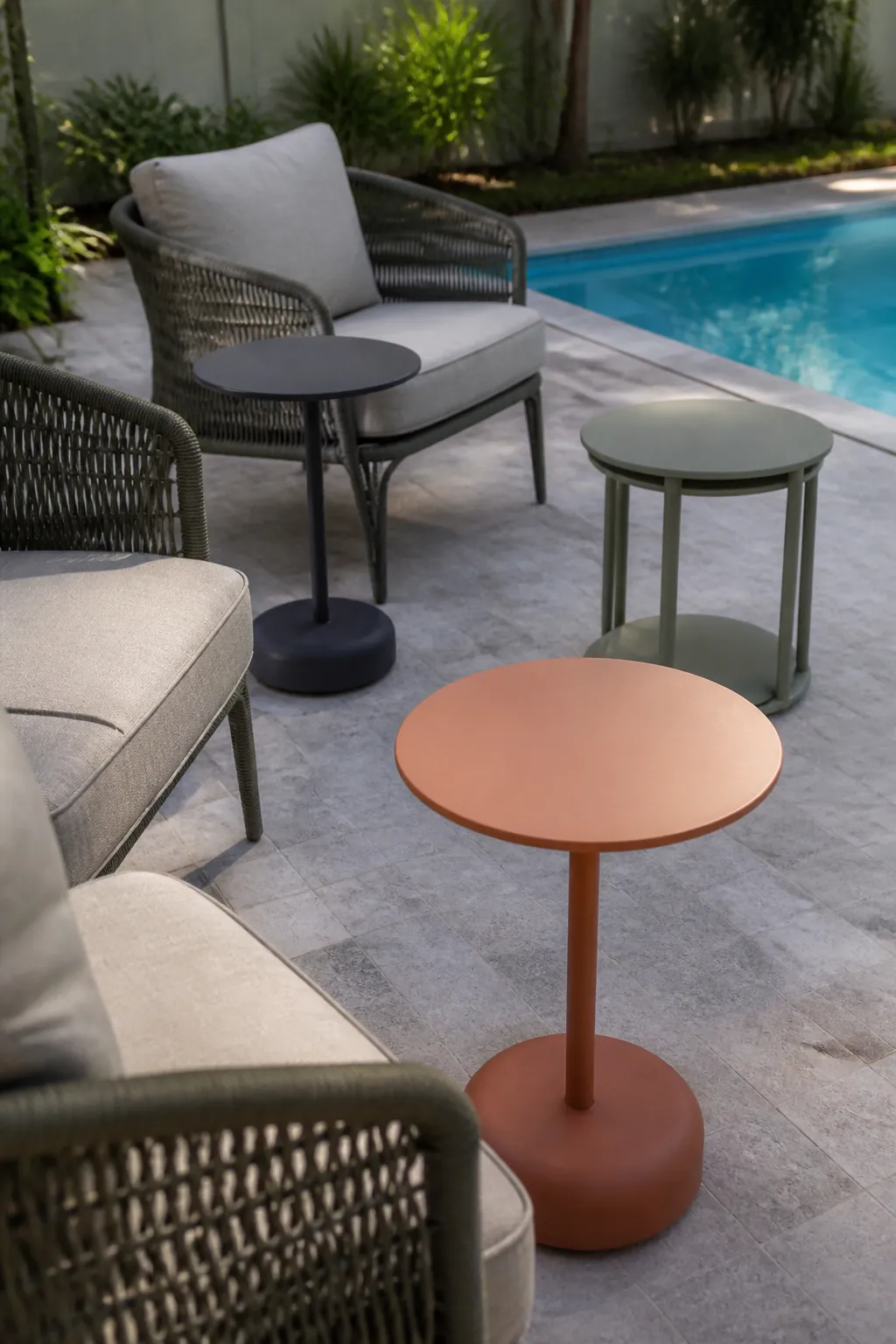 Small nesting side tables serving flexible poolside seating