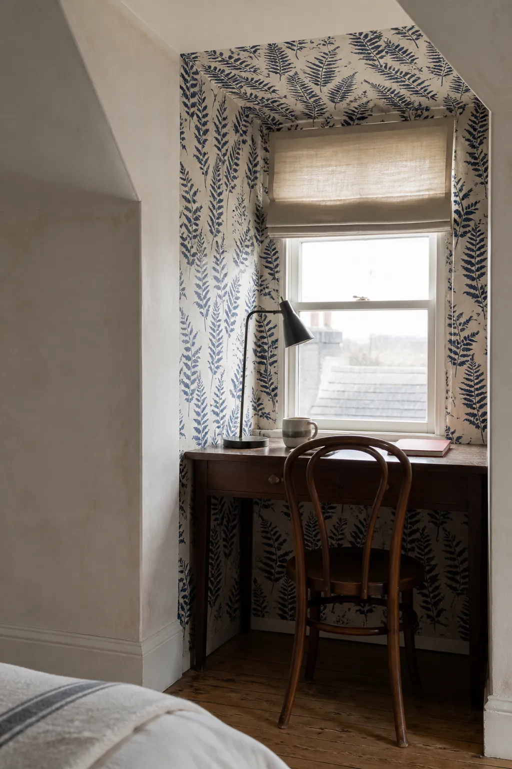 Botanical block-print wallpaper used inside an attic dormer