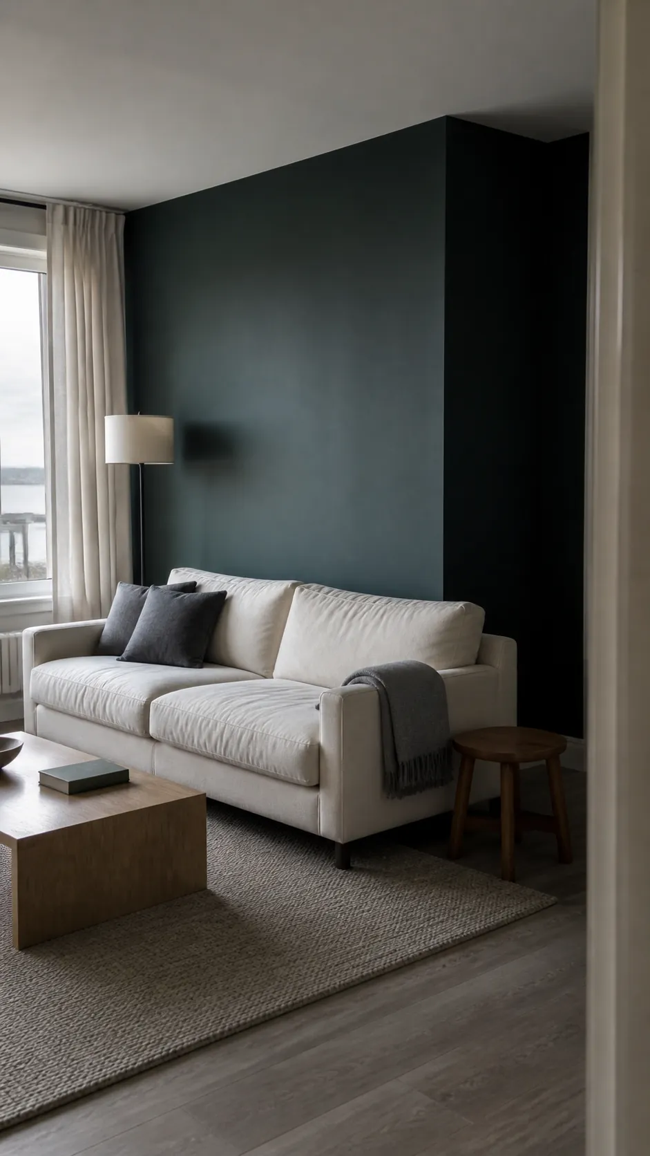 Midnight green living room wall showing blue-green undertones in natural daylight