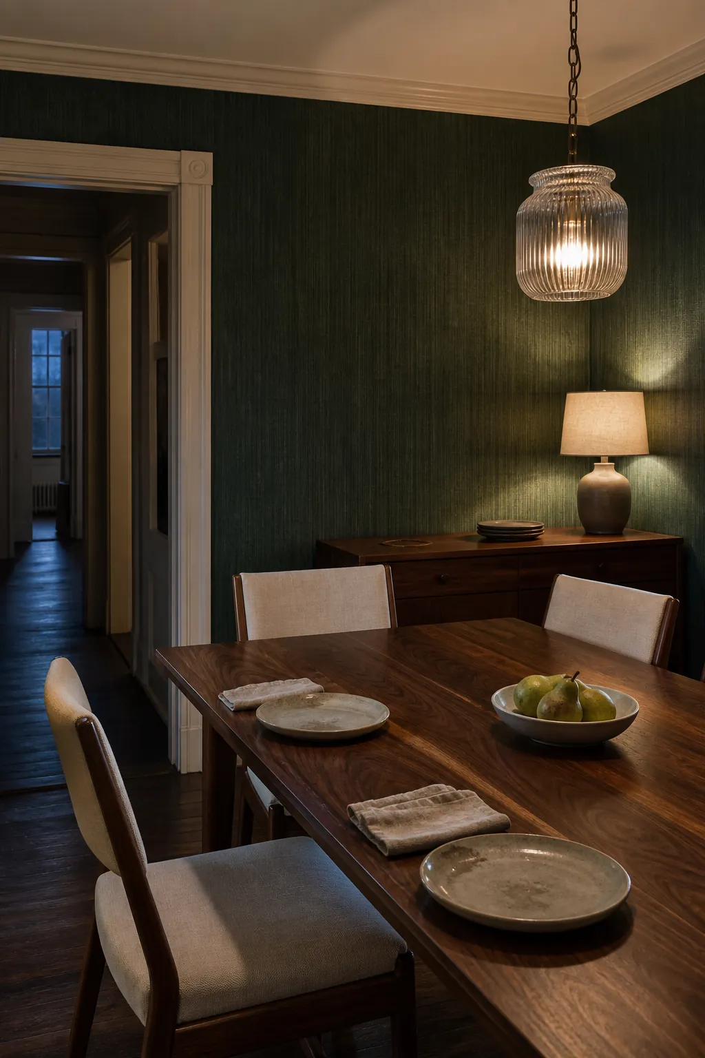 Hunter green dining room paired with a walnut table and cream linen chairs
