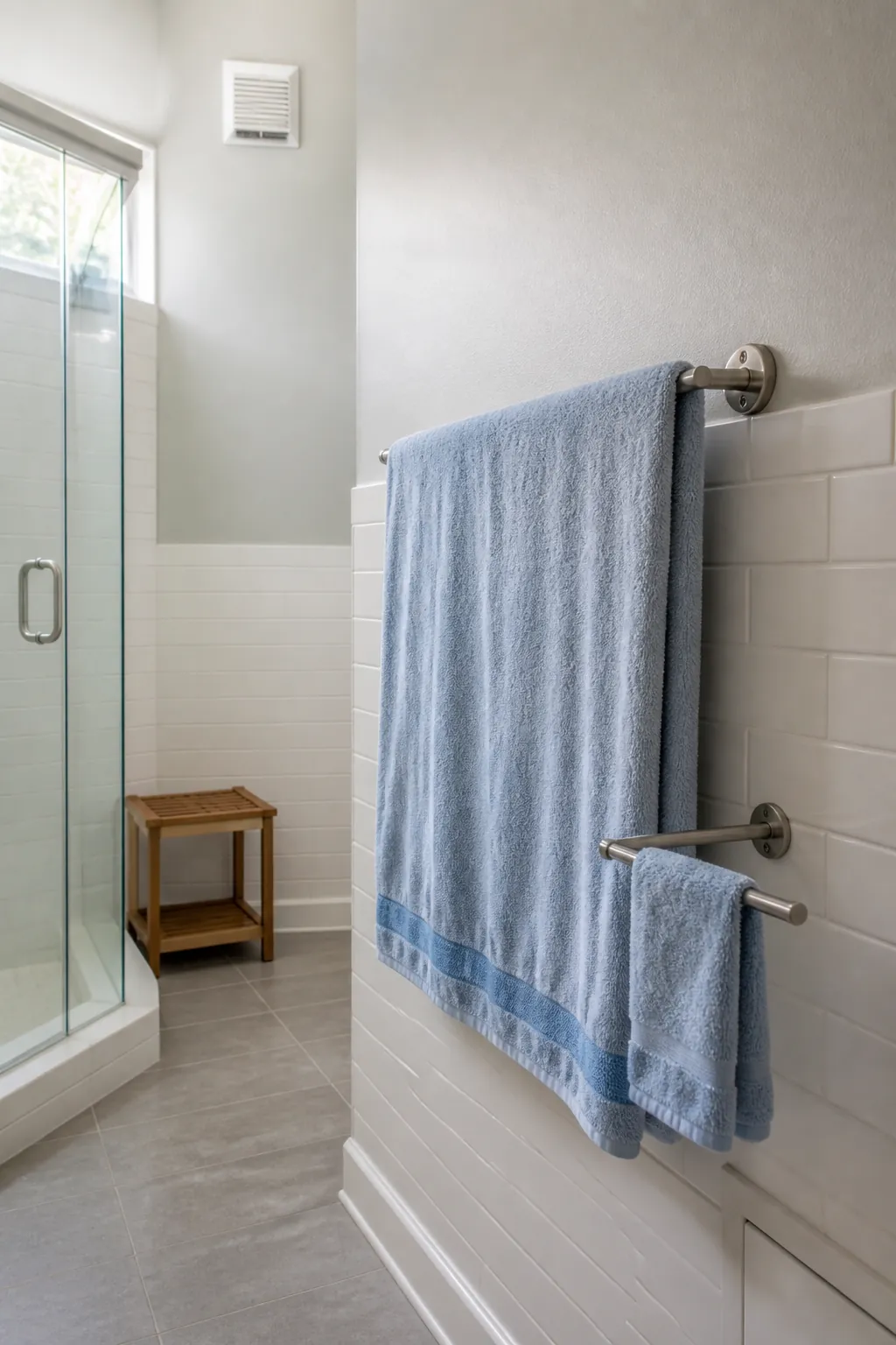 Compact wall mounted towel rack holding one bath towel open