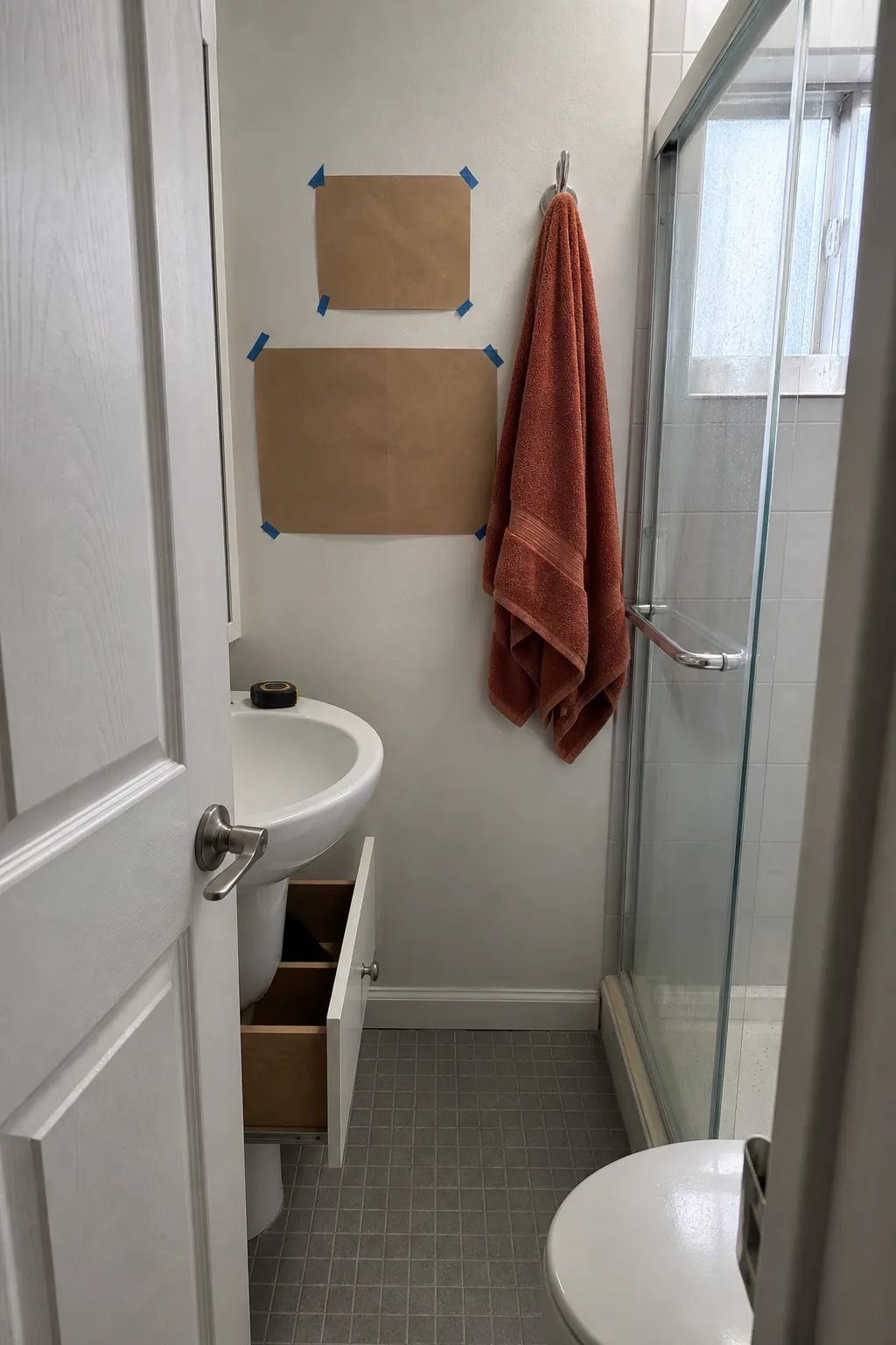 Small bathroom towel placement tested for door and shower clearance