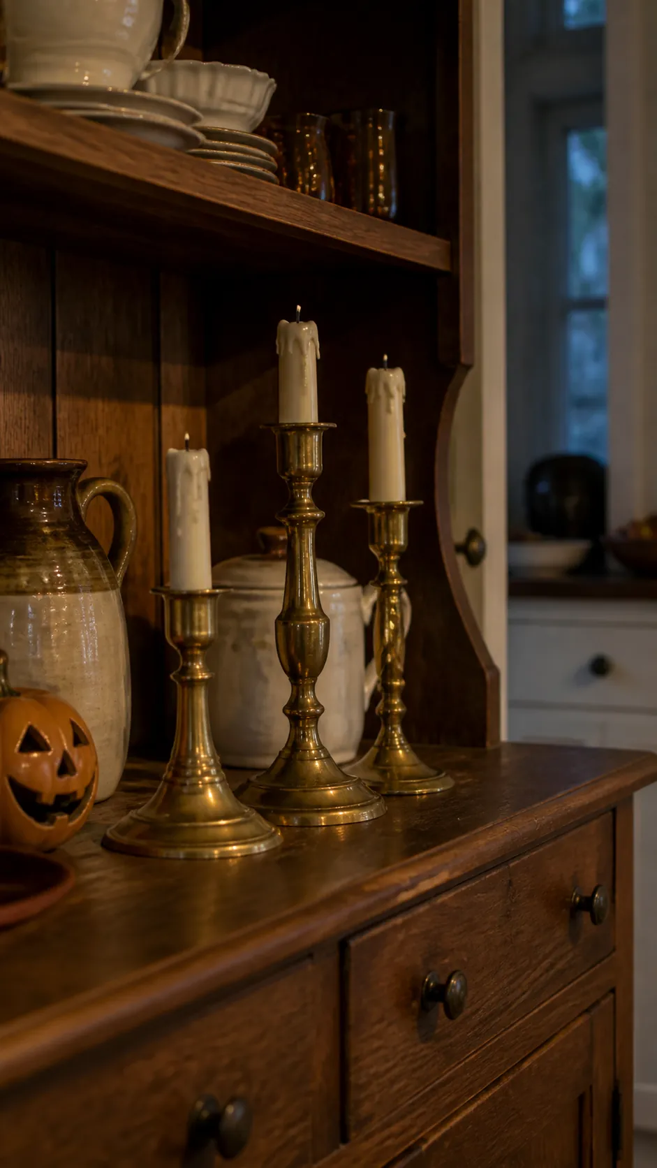 Brass candlesticks with battery lights in a vintage Halloween kitchen