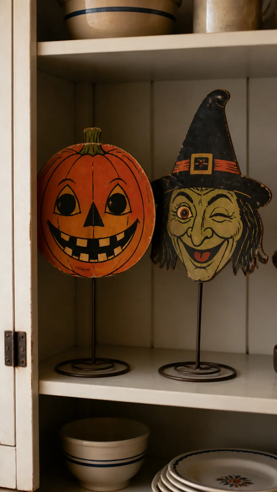 Classic Halloween mask faces displayed on kitchen plate stands