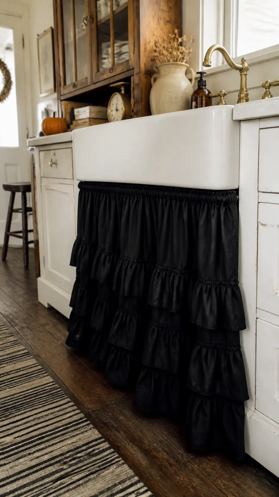 Ruffled black sink skirt in a vintage Halloween kitchen
