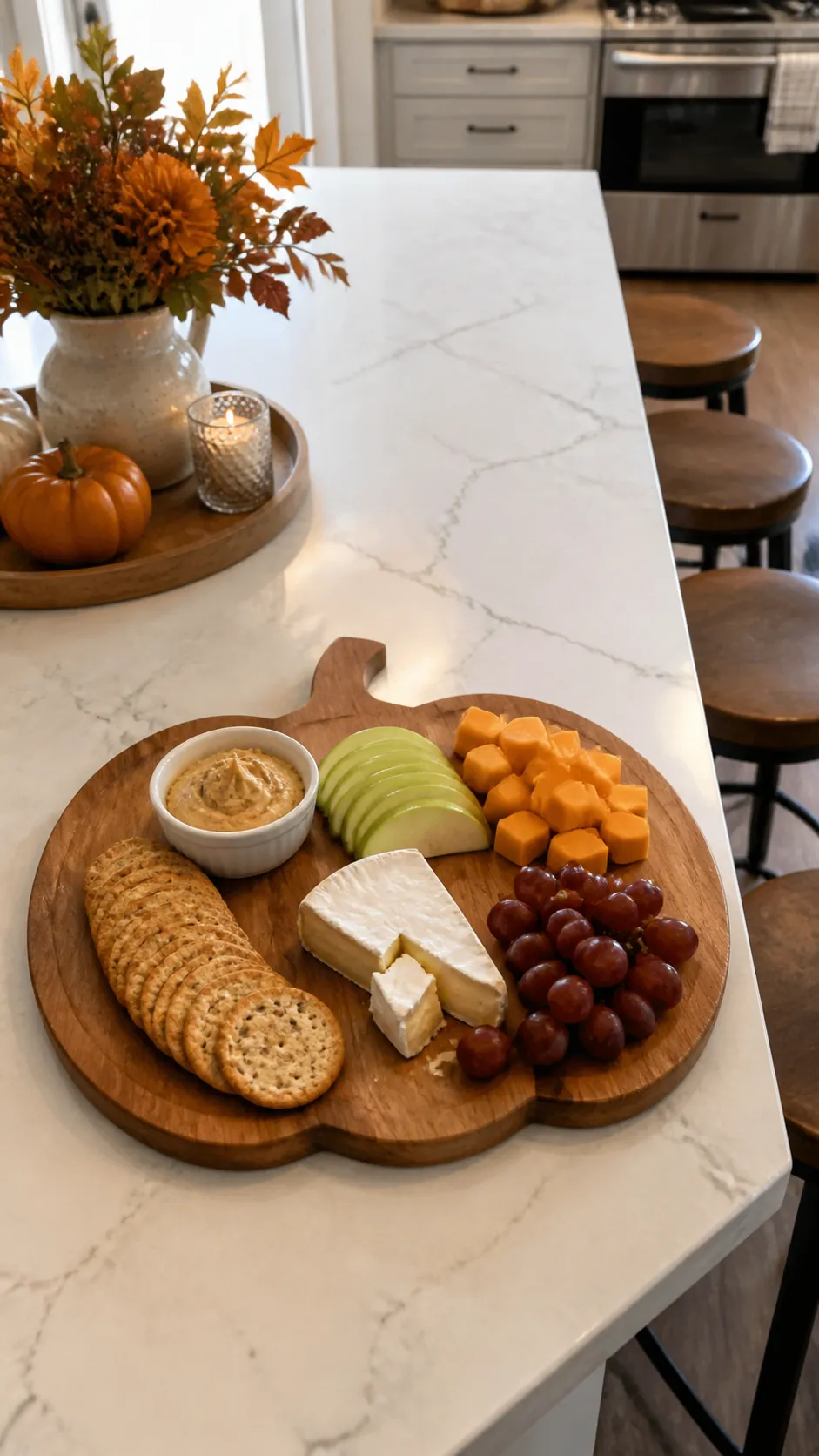 Pumpkin shaped snack board on a Halloween kitchen island